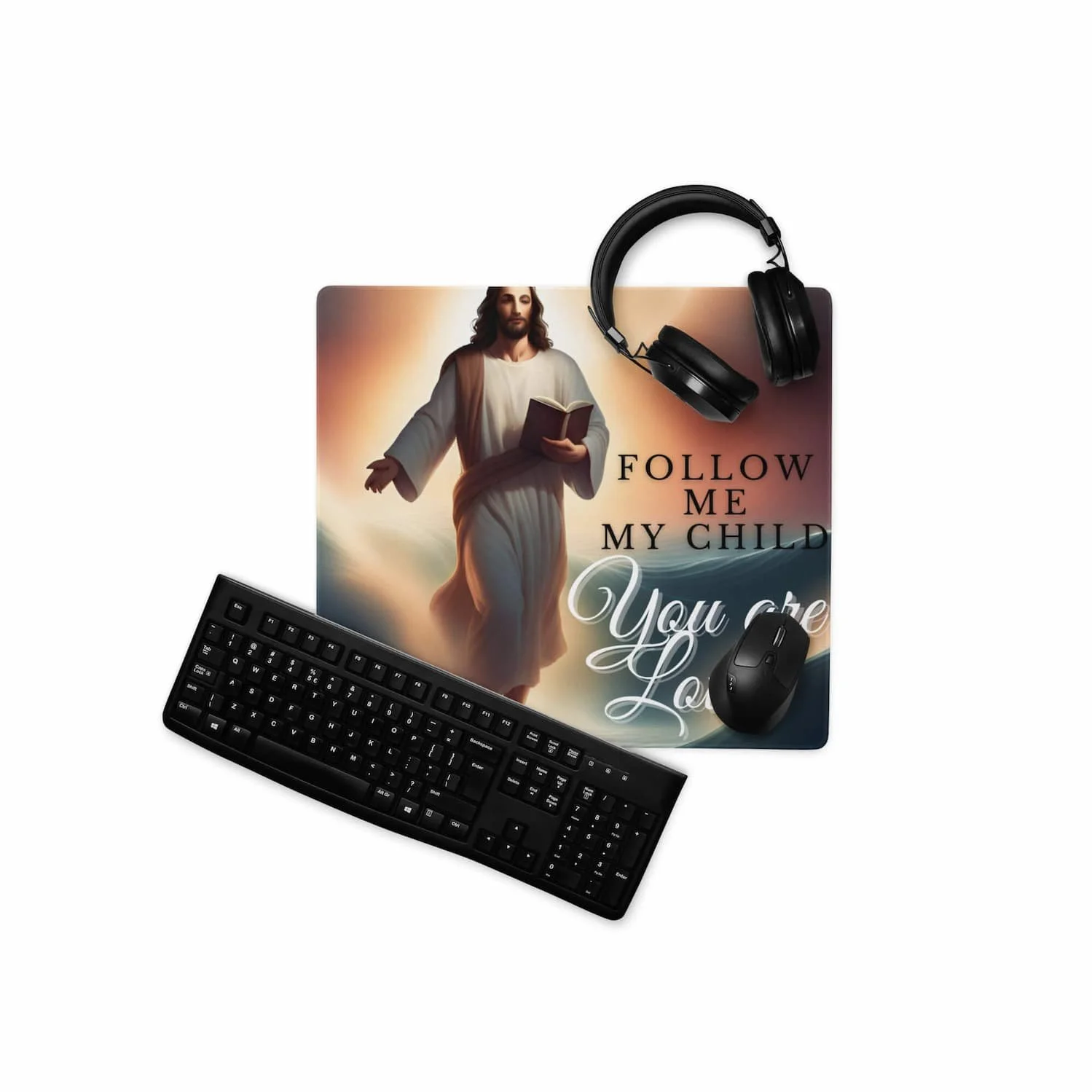 Gaming mouse pad featuring a Jesus walking in the clouds design with the message “Follow Me My Child,” shown with a keyboard and mouse on the extended desk mat