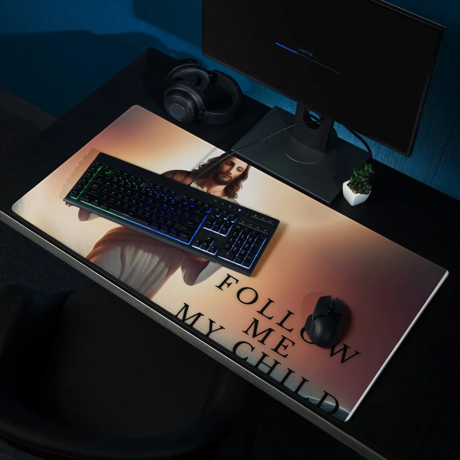 Extended gaming mouse pad featuring Jesus walking in the clouds with the message “Follow Me My Child,” shown with a keyboard and mouse on the desk mat