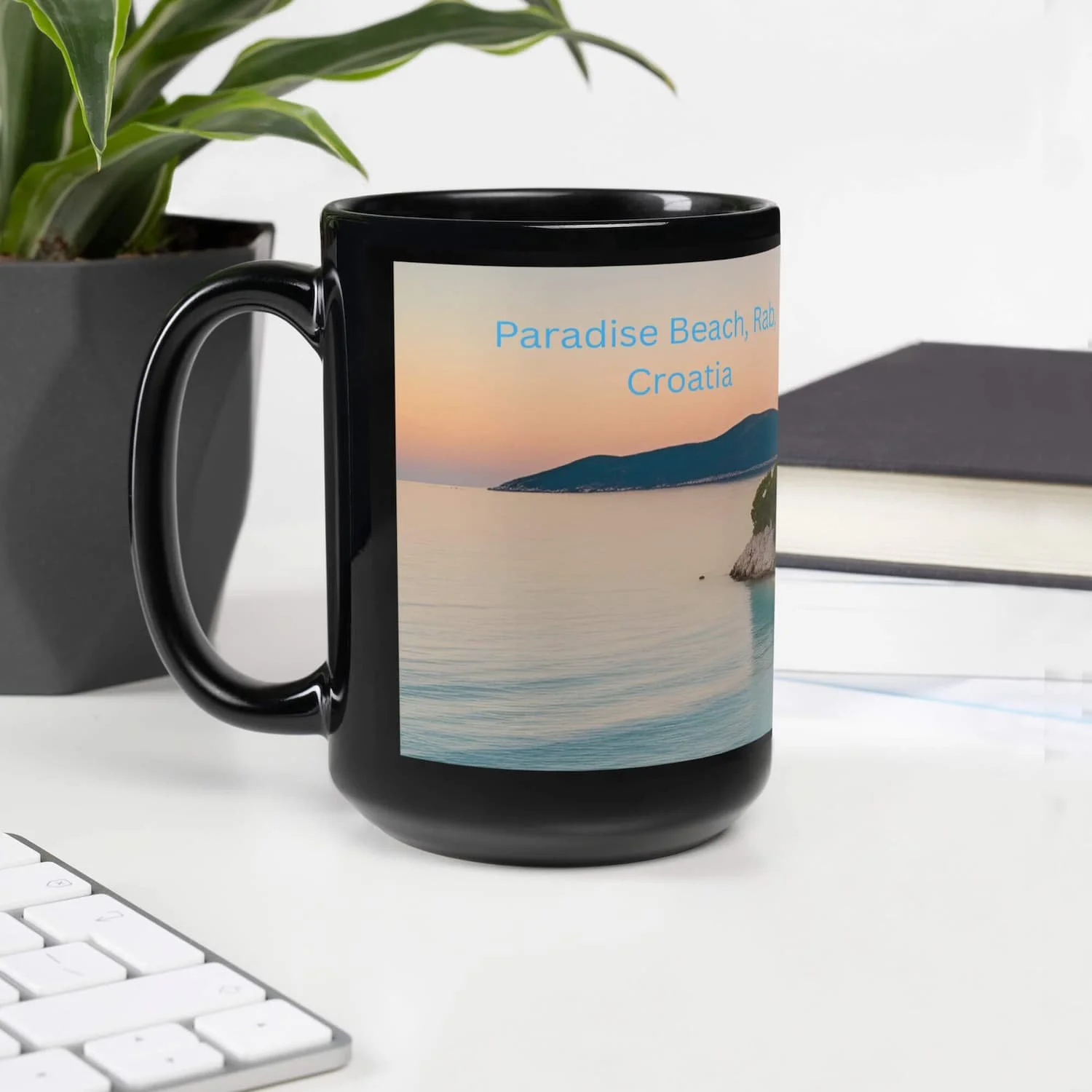 Paradise Beach Coffee Mug 11oz and 15oz next to a small plant in front of a laptop, tropical ceramic coffee mug gift for teachers and beach lovers