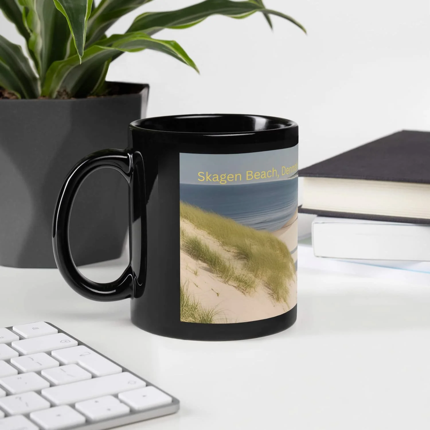 Skagen coastal 11oz left view ceramic mug displayed on a table with a book and plant for Scandinavian-inspired home decor
