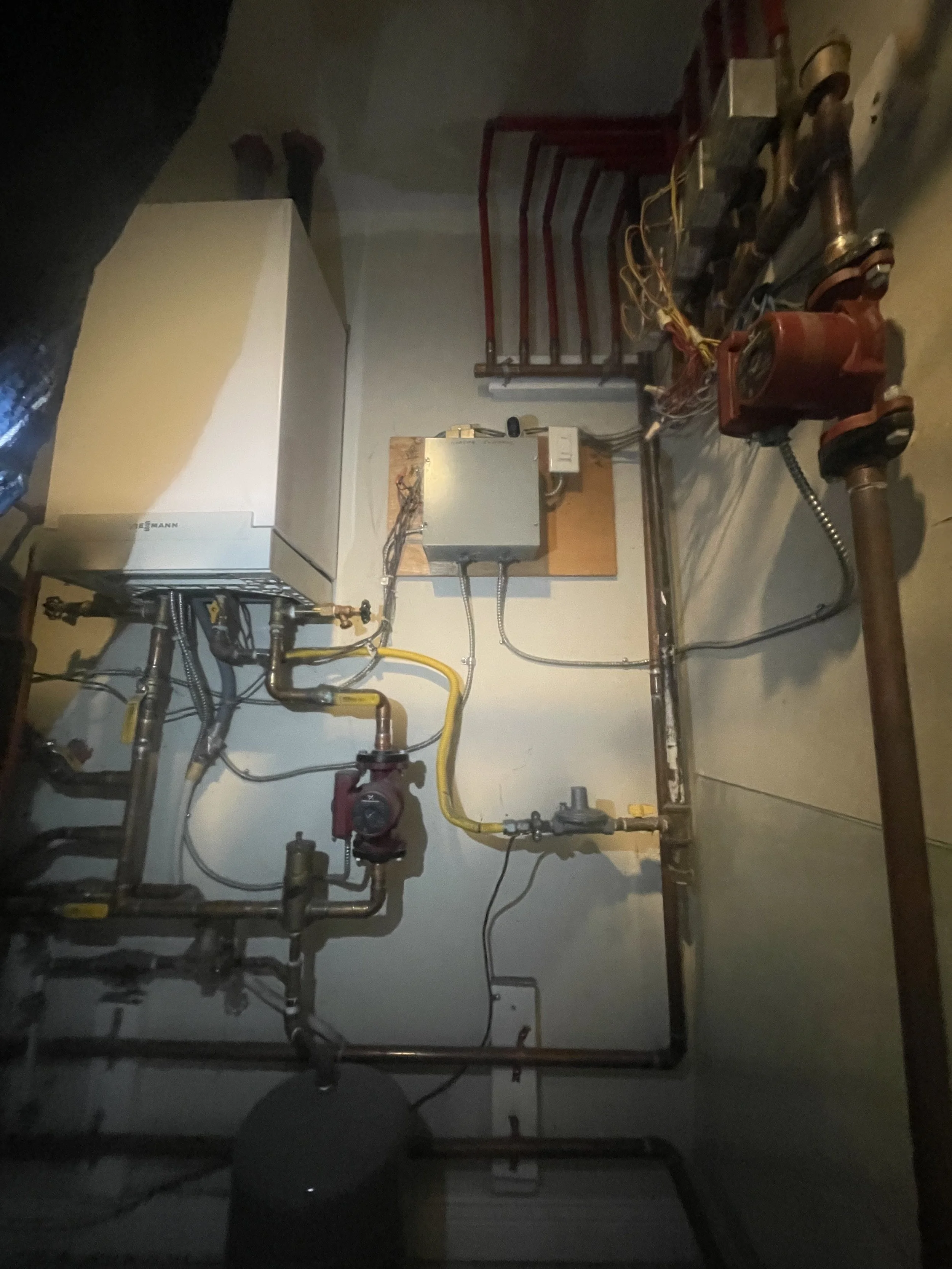 High-efficiency boiler installation with indirect hot water tank and heating system piping for residential heating and hot water in Vancouver BC