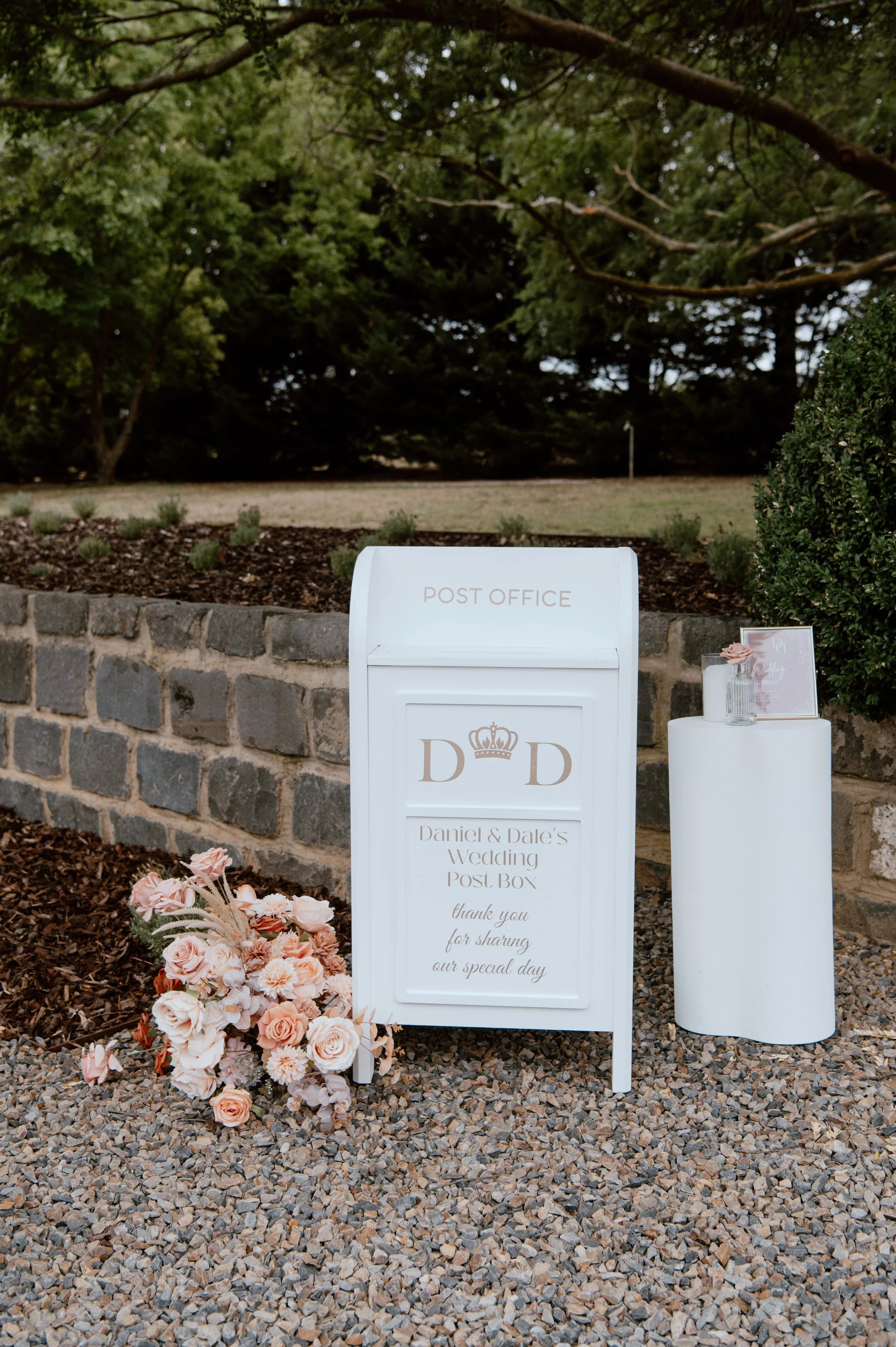 White collapsible wedding wishing well mailbox styled like a post box—used for collecting cards and messages at weddings and events. Customisable panel, flat-pack design, available for hire in Melbourne.