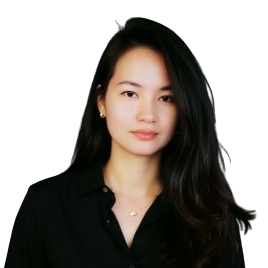 A woman with long black hair, wearing a black collared shirt and small earrings, posing against a white background.