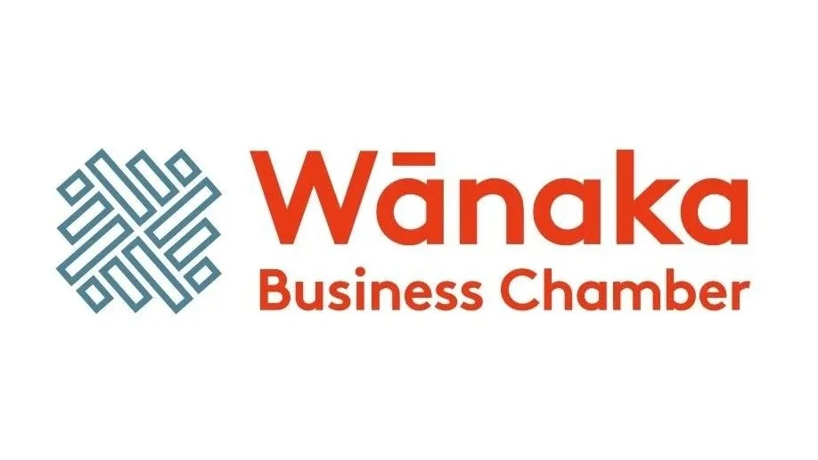 Logo of Wānaka Business Chamber with a blue geometric emblem and red text.