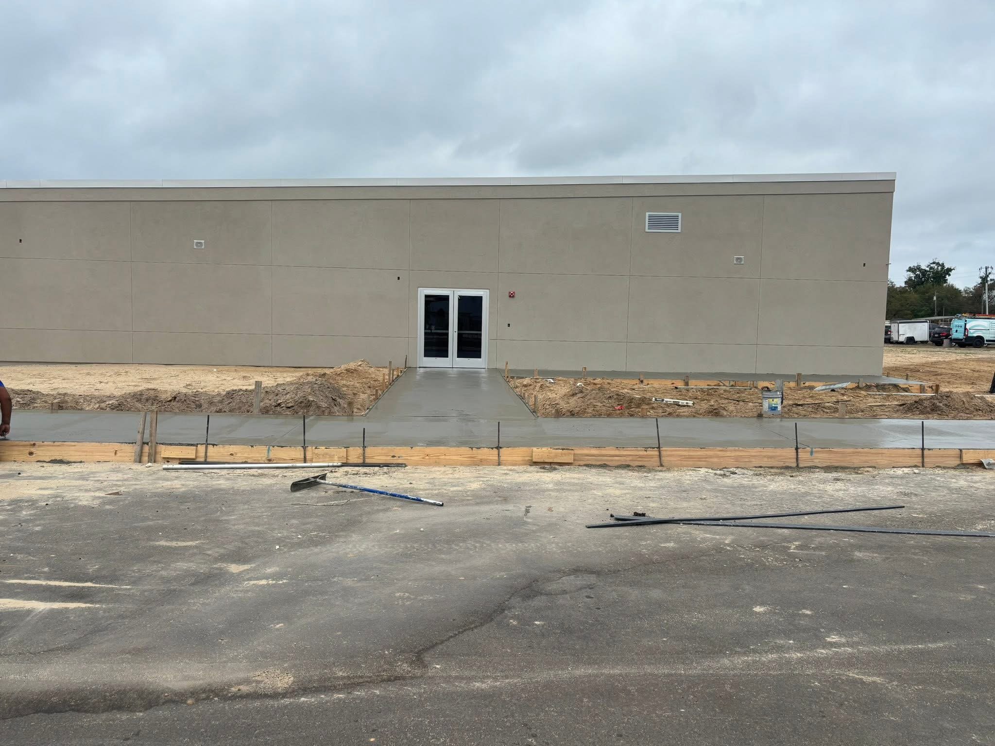 New concrete for sidewalk to enter building.