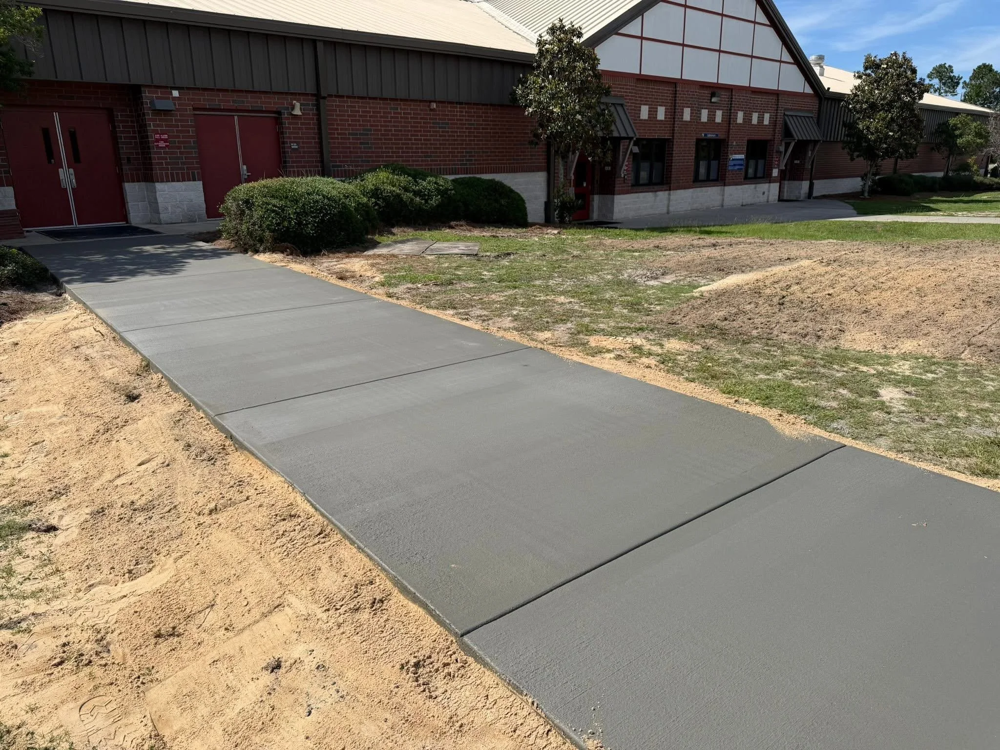 Concrete walkway connecting drop off area to the school.