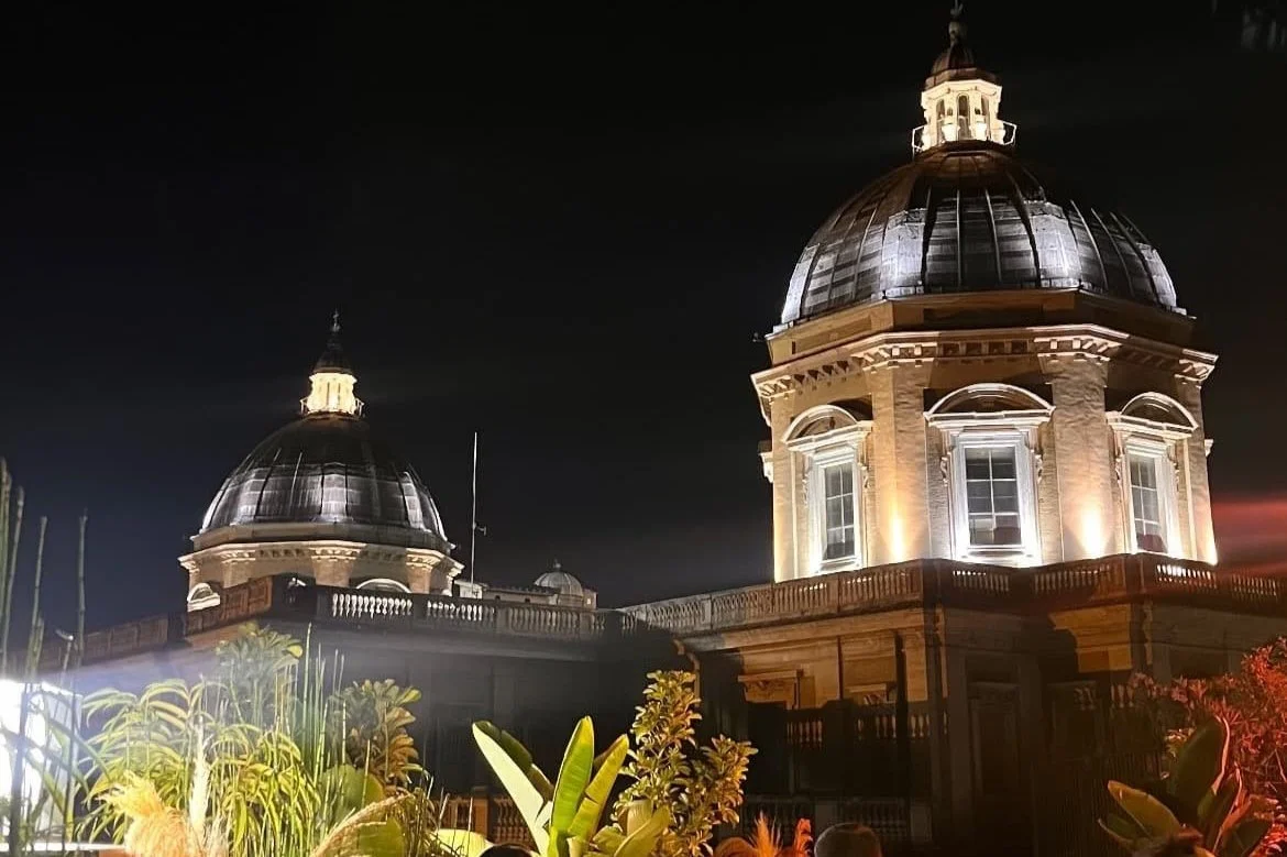 Enjoying cocktails at Masa Rooftop Bar with panoramic sunset views over Rome.