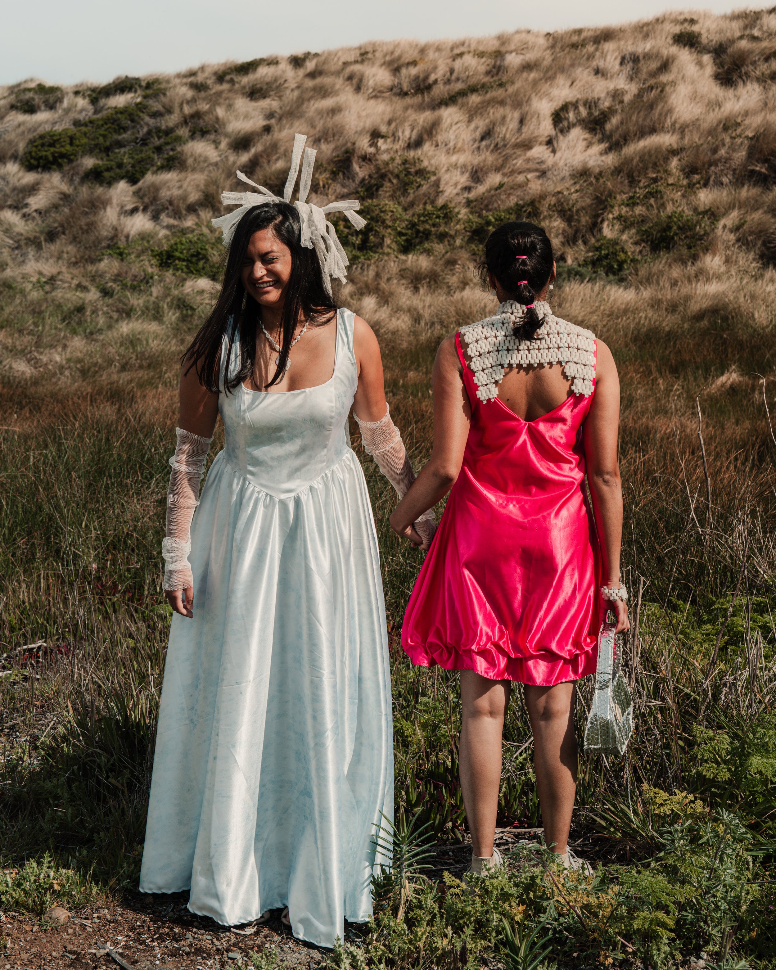 Left: Cyanotype printed gown by Katie Erickson, pearl necklace by Erica Goodwin, woven mesh headpiece and gloves by Sitoë Thiam.
Right: Bioball beaded collar by Sitoë Thiam, ruffle slip dress by Katie Erickson, silver thermal shield purse by Anna G