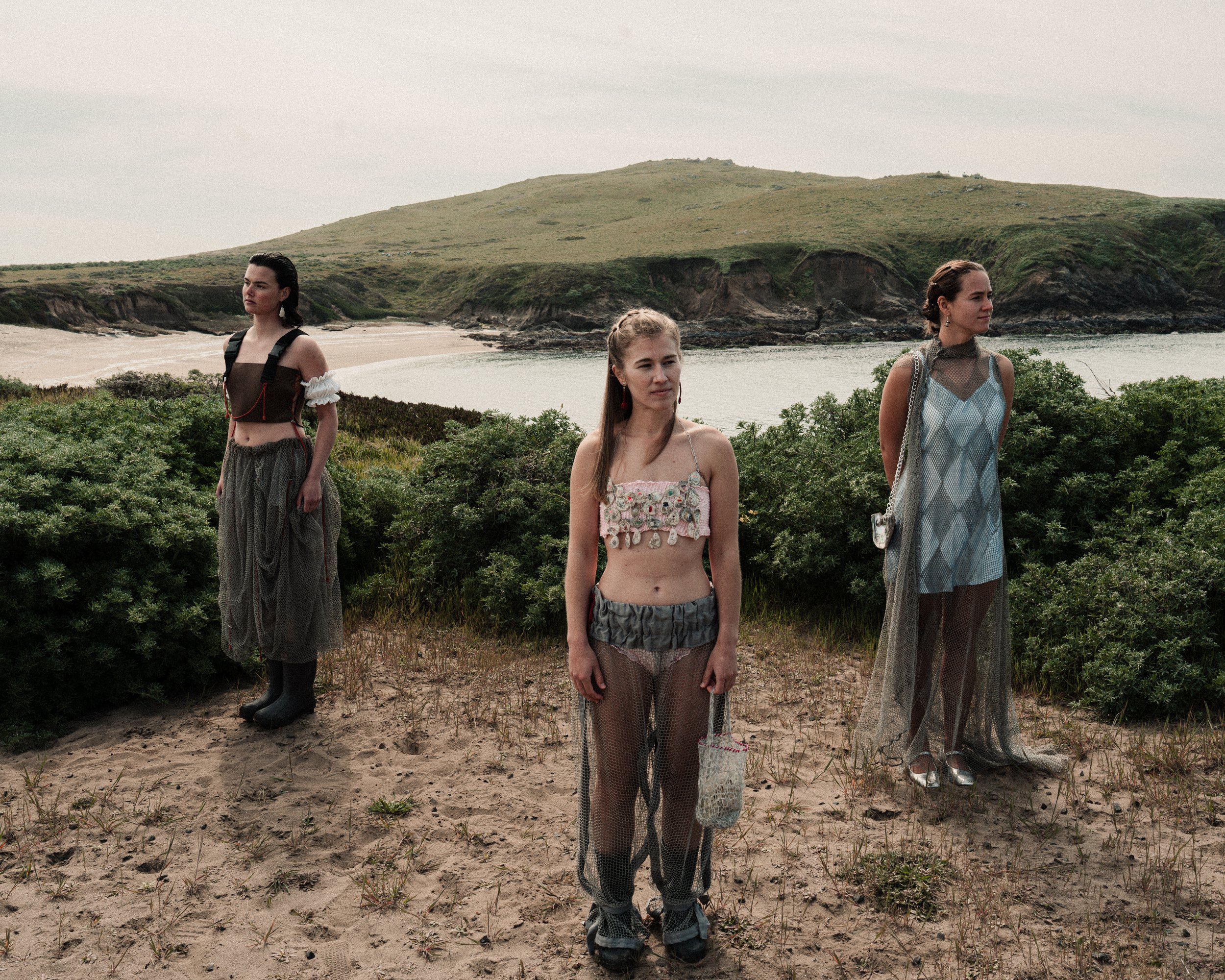 Left: Upcycled wader top by Katie Erickson and Sitoë Thiam, ruffle sleeves and bloomers by Katie Erickson, reclaimed fishing net bubble skirt by Sitoë Thiam, shell earrings by Erica Goodwin.
Center: Shell chainmail top by Erica Goodwin, ruched band