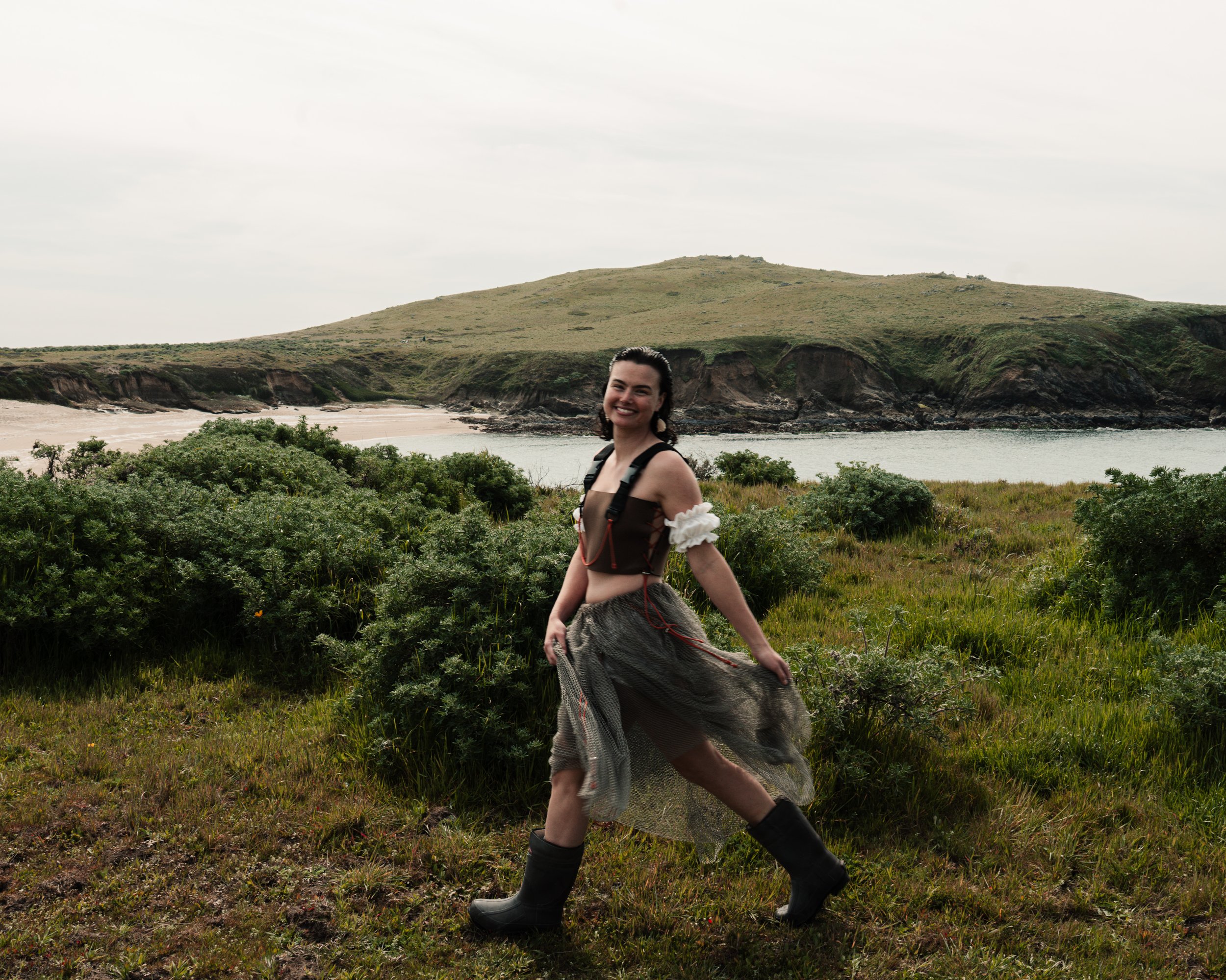 Upcycled wader top by Katie Erickson and Sitoë Thiam, ruffle sleeves and bloomers by Katie Erickson, reclaimed fishing net bubble skirt by Sitoë Thiam, shell earrings by Erica Goodwin.
Photo by Jonathan Aguiñaga