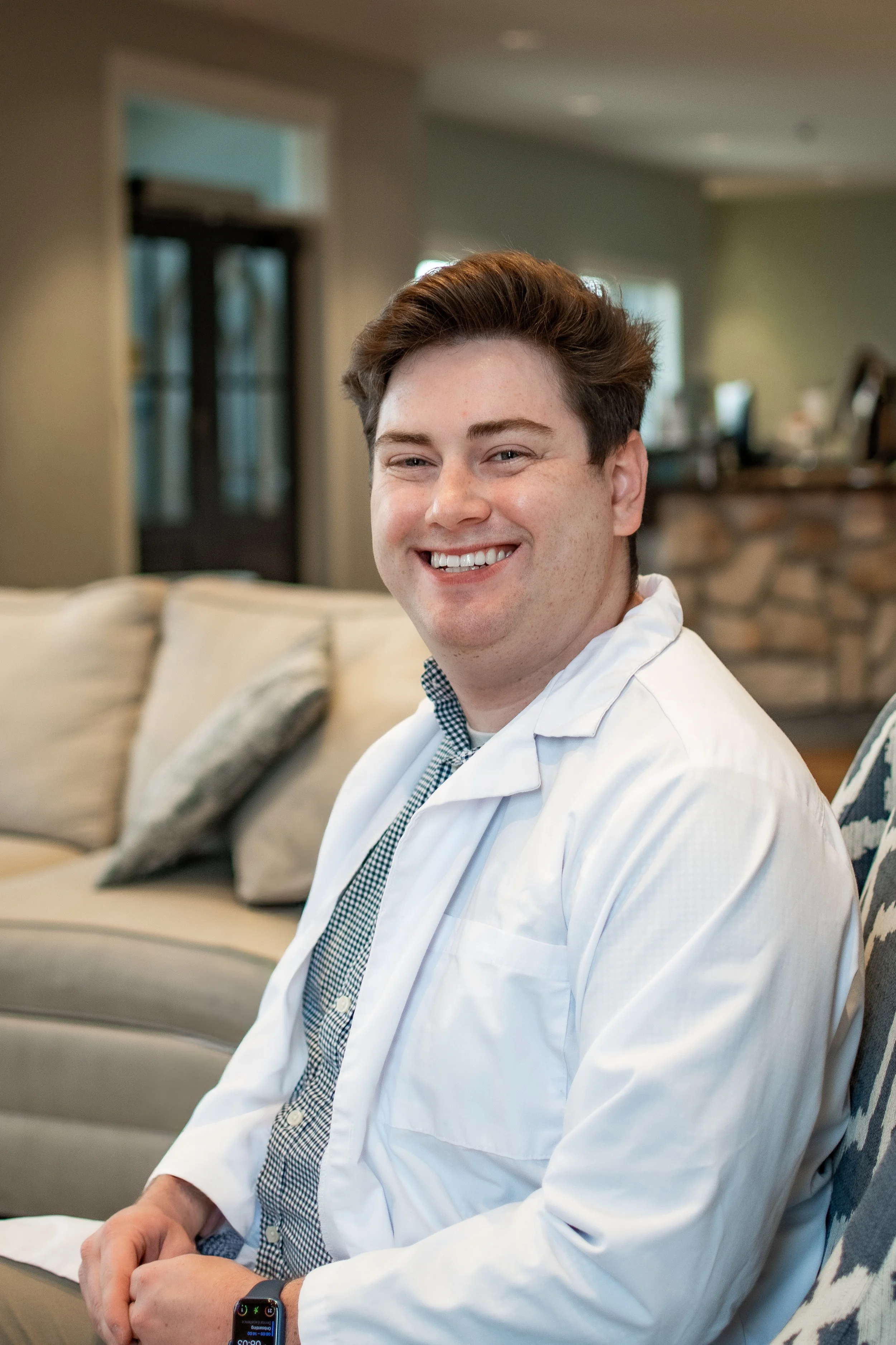 Dr. Meade, dentist at Dental Excellence of Bowling Green, smiling in a white lab coat