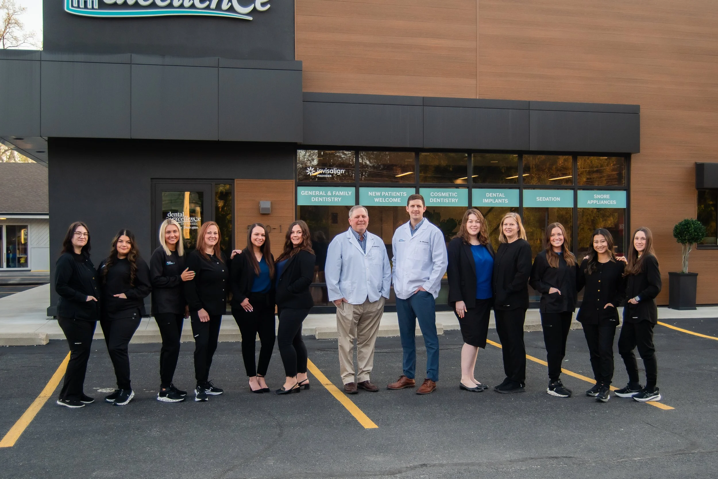 Dental Excellence of Sylvania team standing outside the office, providing compassionate family and cosmetic dentistry in Sylvania, Ohio.