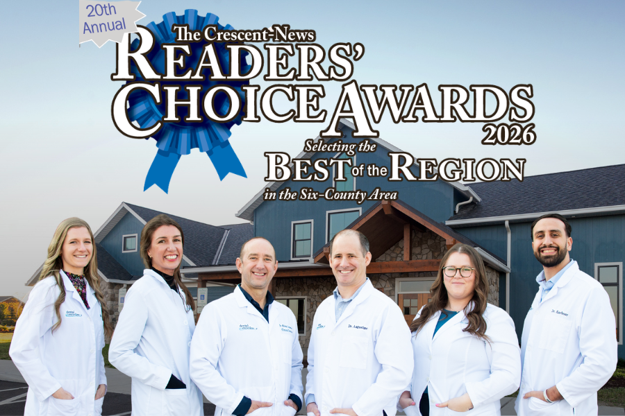 Dental Excellence doctors team promoting 2026 Readers Choice Awards in front of Napoleon office building