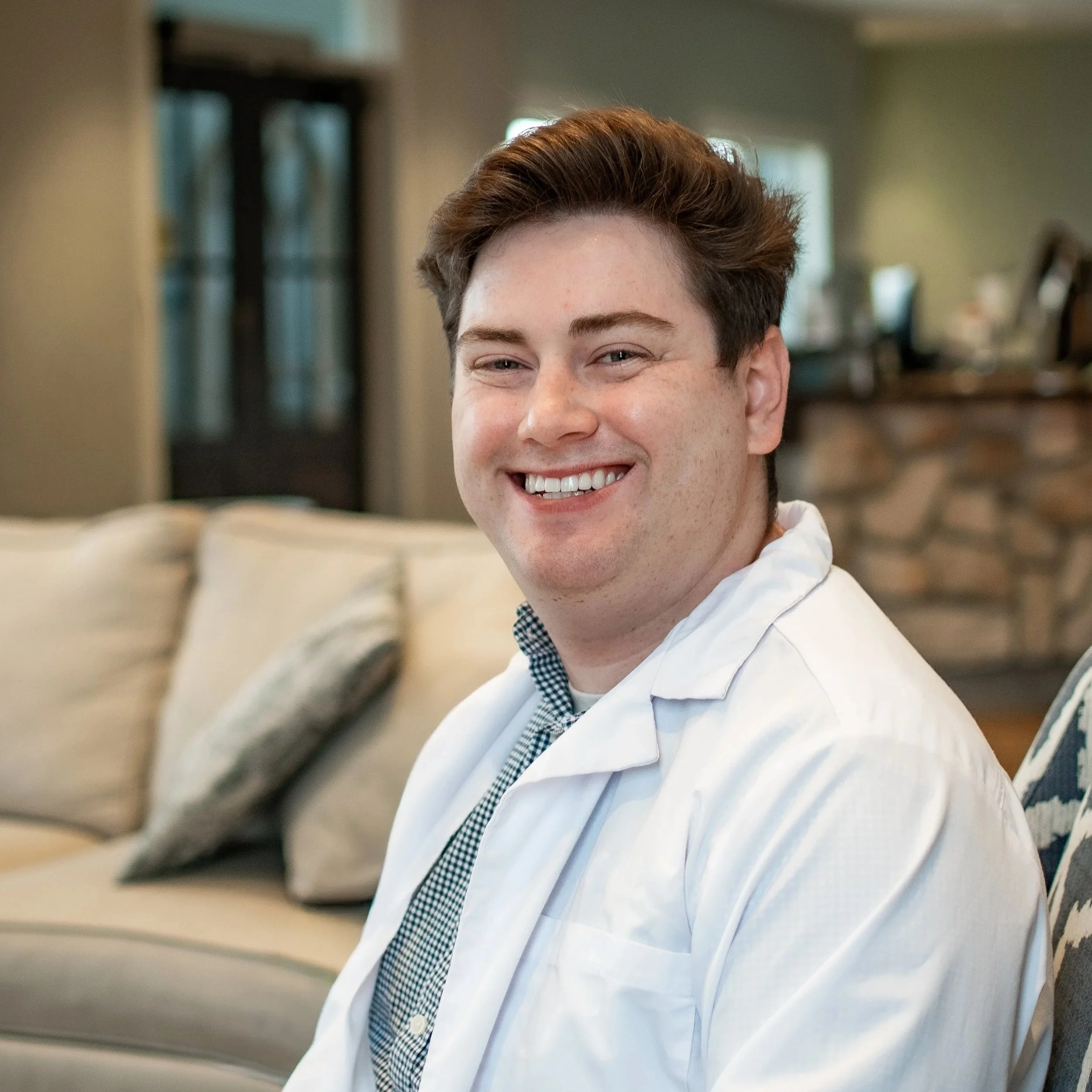 Dr. Meade, dentist at Dental Excellence of Bowling Green, smiling in a white lab coat
