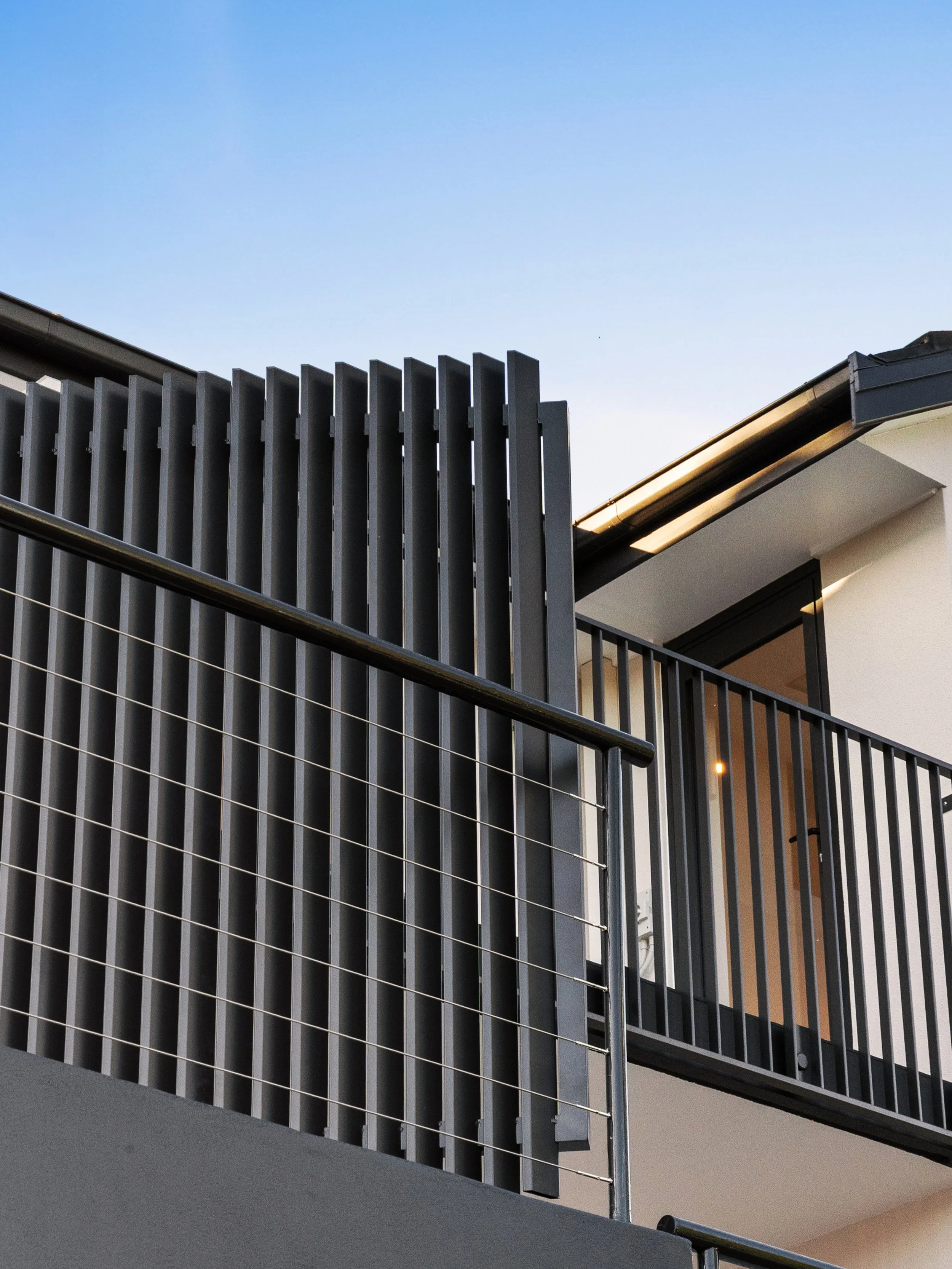 Clean lines, Monument and a bit of late-afternoon light.

The aluminium screen gives this courtyard privacy without closing it in, and the colour carries through the railings and window frames so the whole facade reads as one.

Small details, done pr