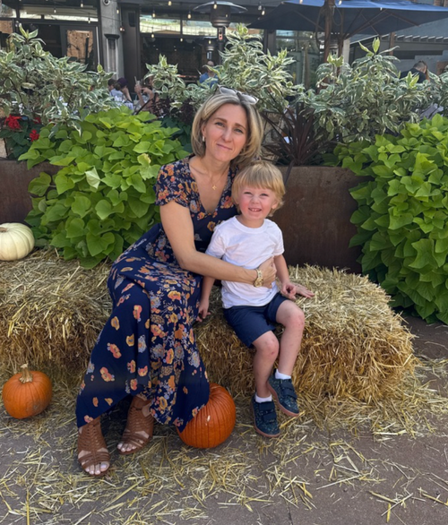 Diana and Luke on hay bales with pumpkins