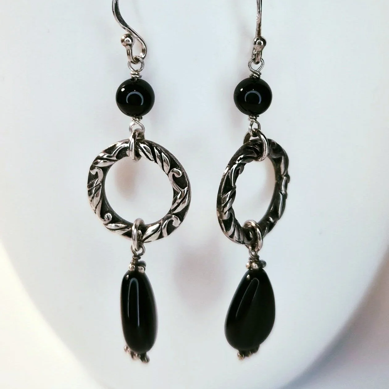 &spades; Onyx Teardrop - a Matched Earring Find. &spades;

Stamped 925 on the reverse, these earrings reflect high-quality silverwork and a beautifully balanced design. The engraved leaf-like scrollwork on the hoops adds a refined touch, making them 
