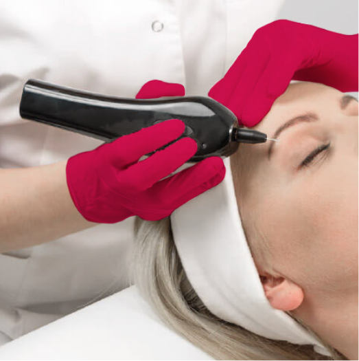 A woman receiving a facial treatment with a device applied to her forehead, while lying down with a white headband, and a practitioner wearing red gloves.