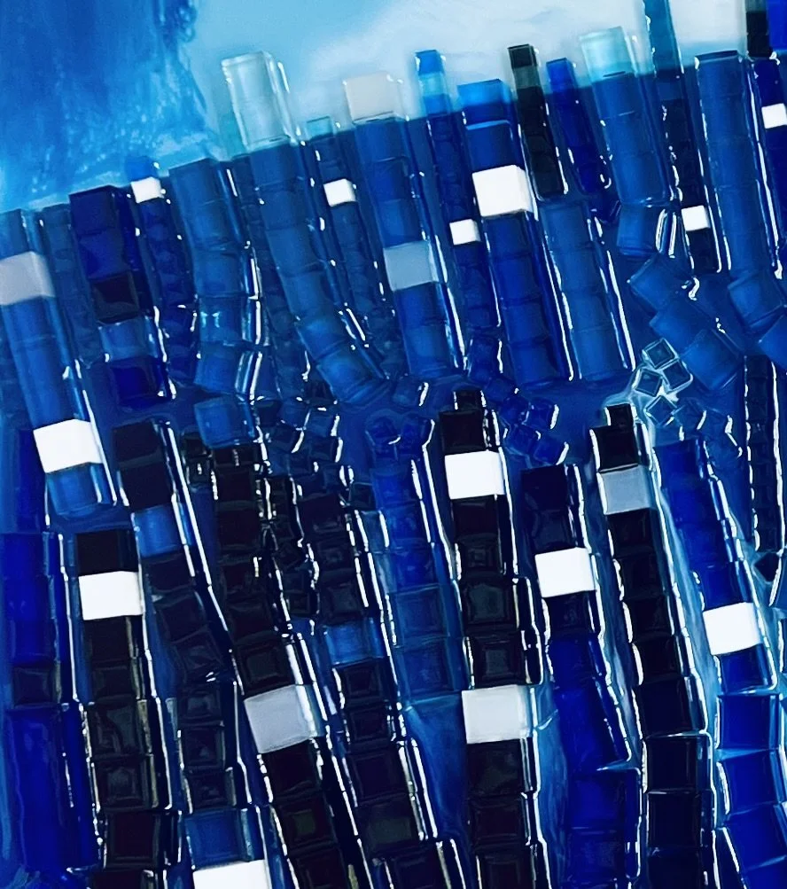 A collection of blue and black plastic fireworks tubes with white labels, arranged in rows.