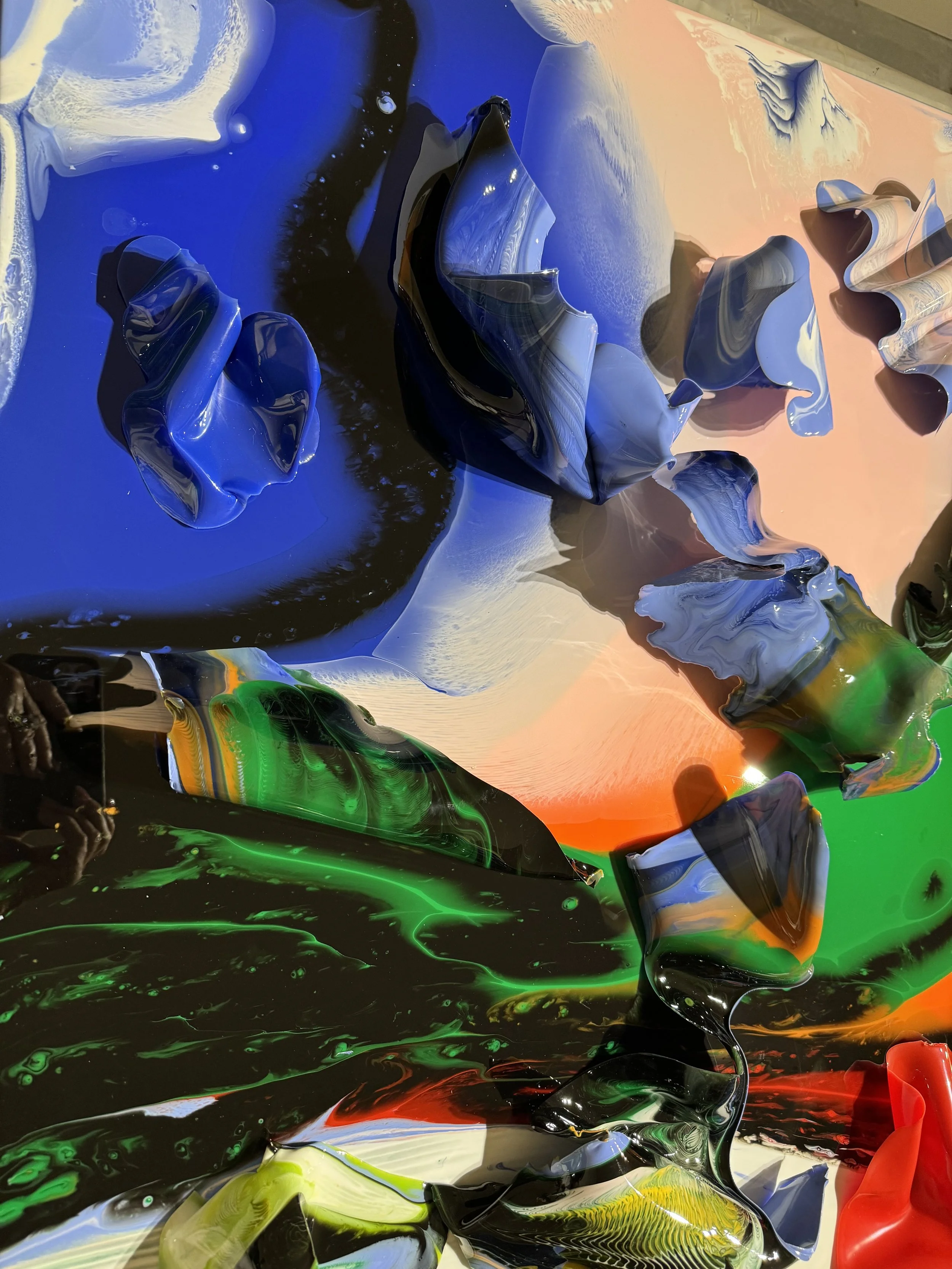 Colorful abstract art with swirling paint and curving shapes in blue, black, green, yellow, orange, and red hues.