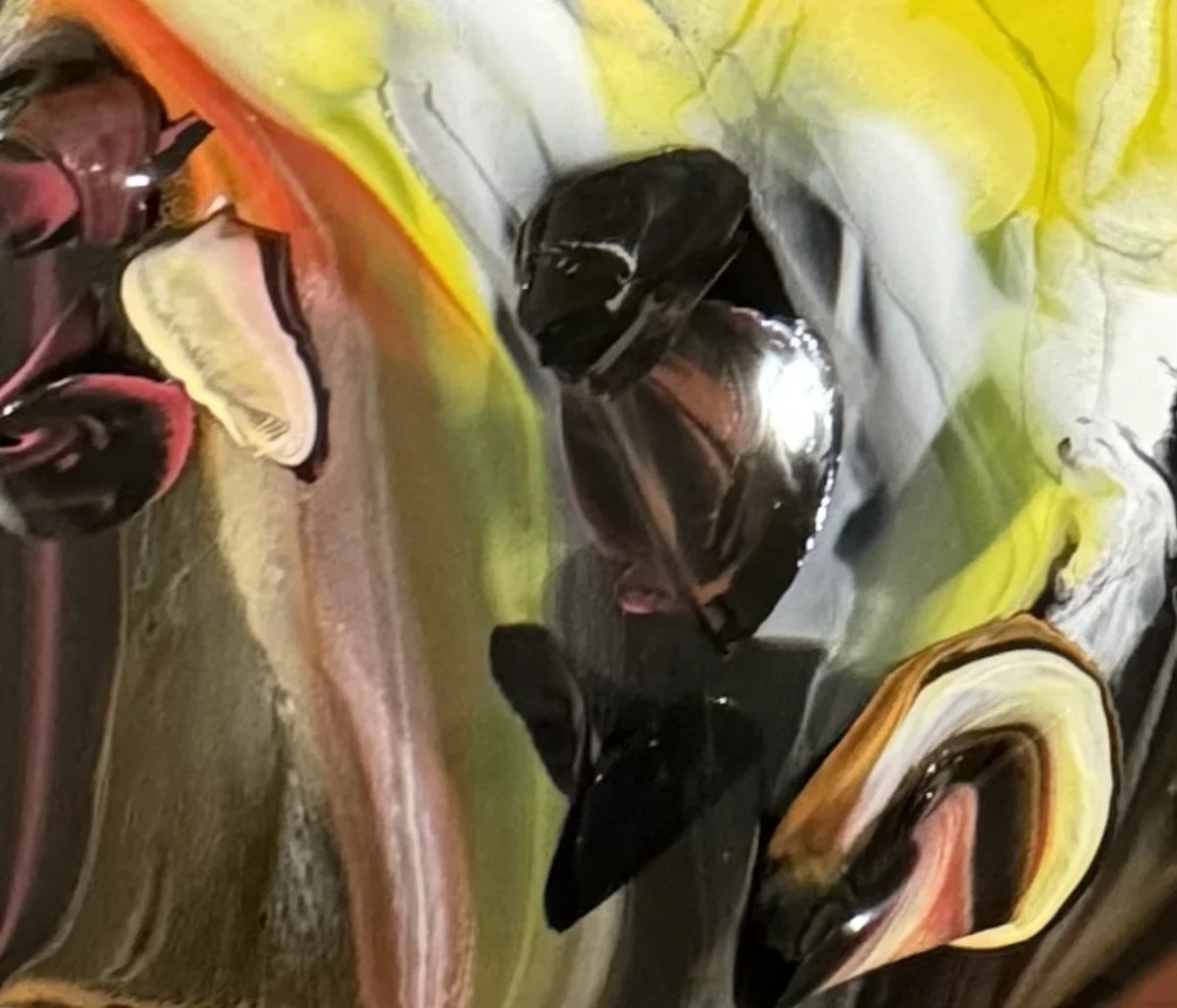 Abstract colorful swirling pattern with shades of yellow, orange, black, white, pink, and gray.