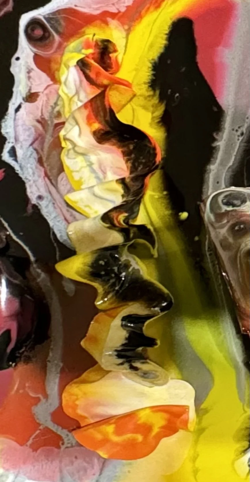 Abstract watercolor painting with swirling colors of pink, red, orange, yellow, black, and white.