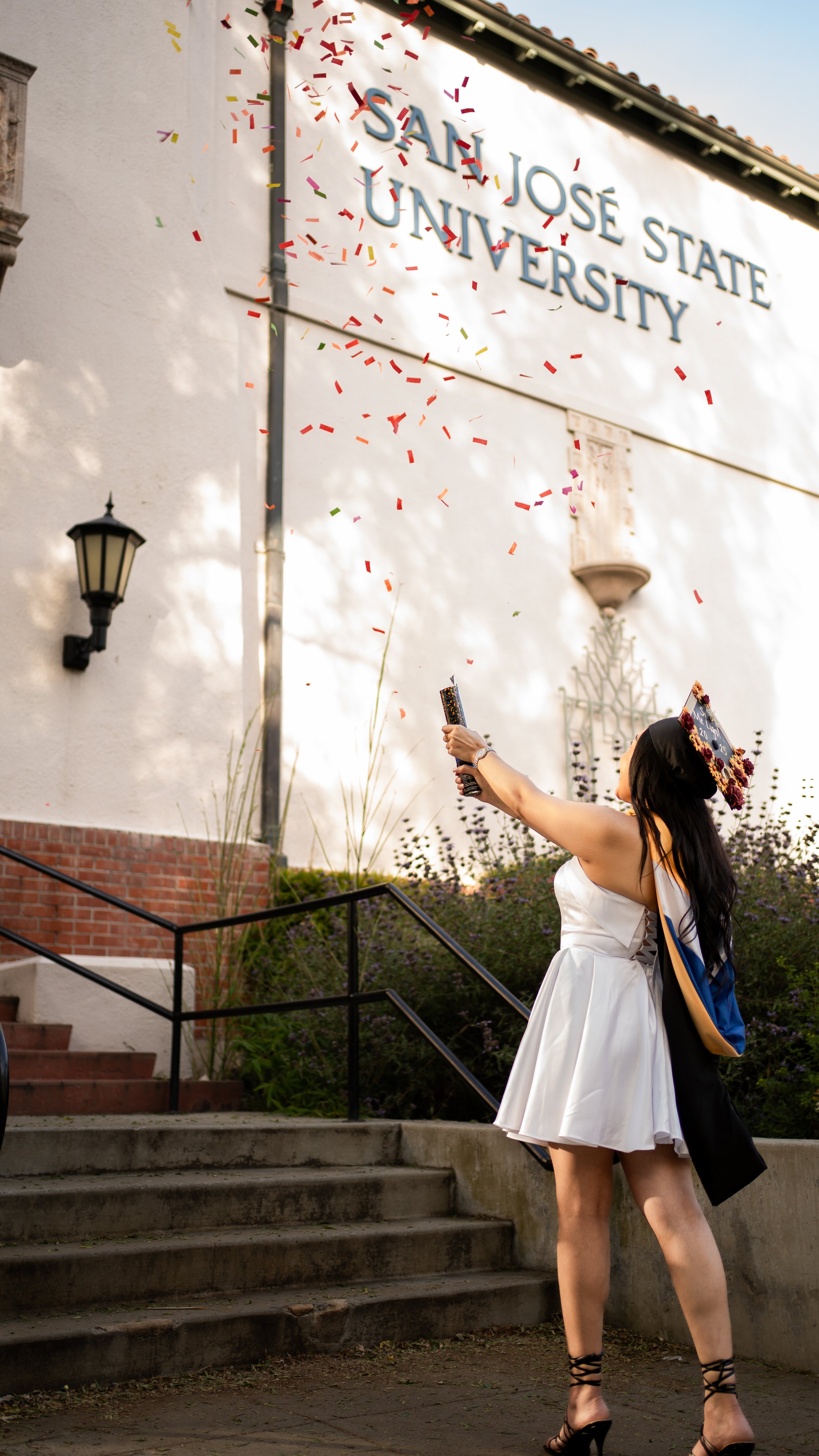 a young woman celebrating her graduation from a university.