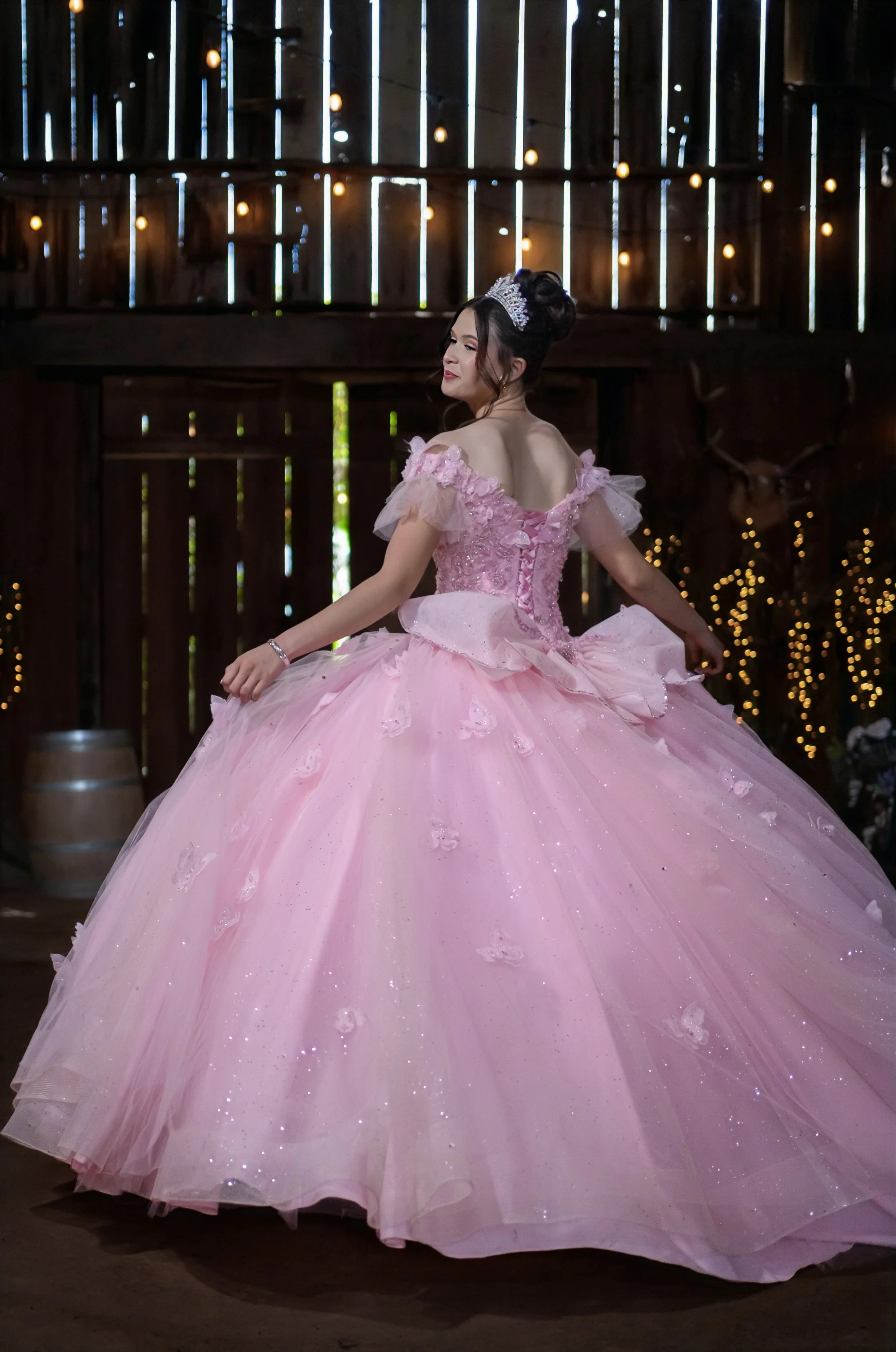 a young lady with a pink dress prancing around celebrating her quinceañera 