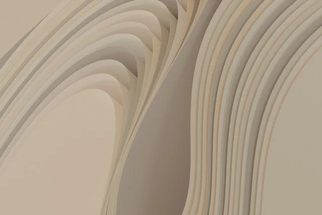 Close-up of stacked white paper sheets viewed from the side.
