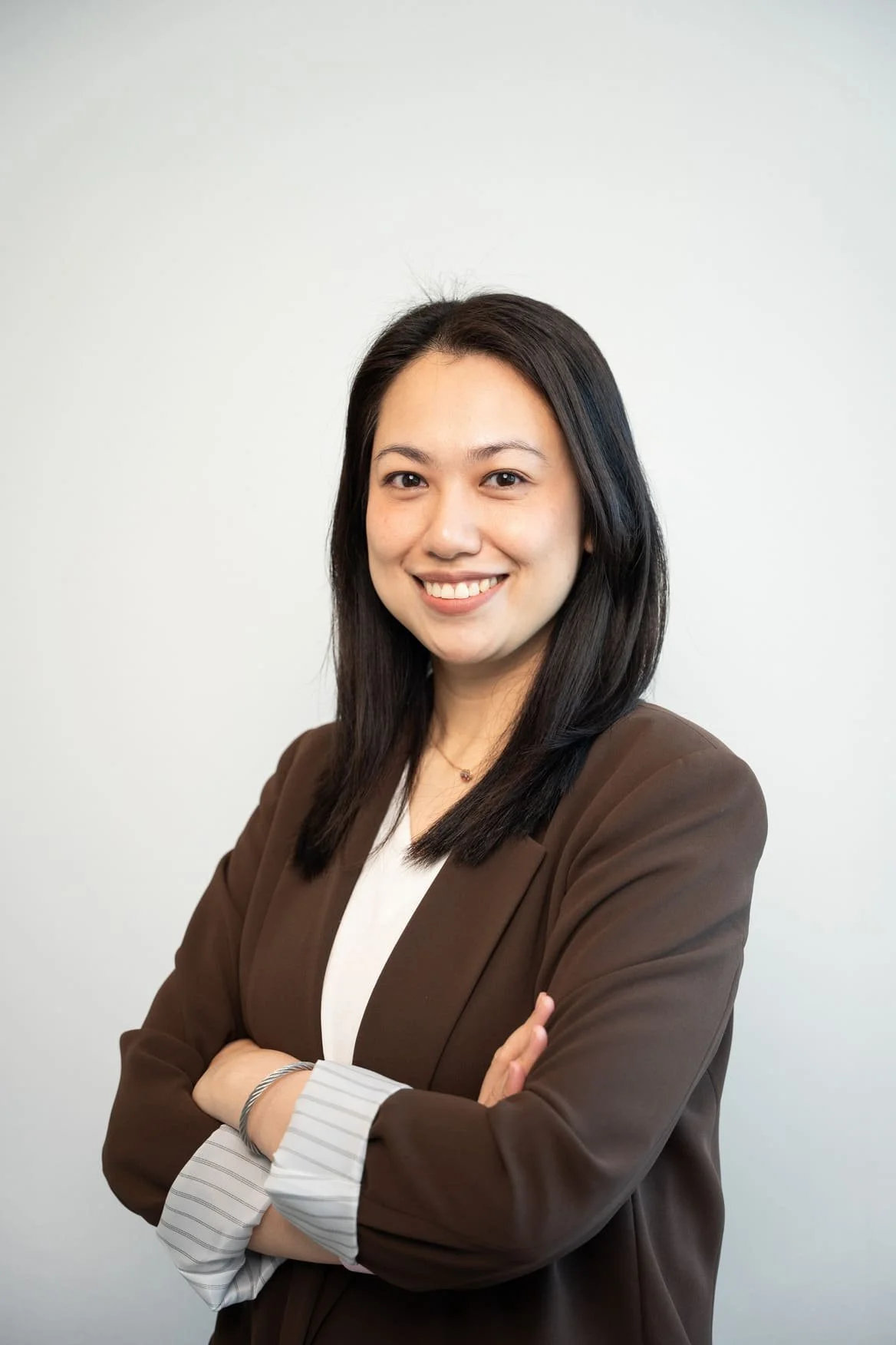 Ailien Sy, Peninsula's psychologist, sitting in a chair facing the photo.
