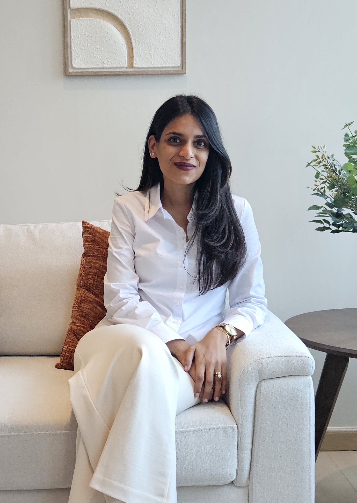 Lauren, Peninsula's Psychologist, sitting in a sofa facing the photo.
