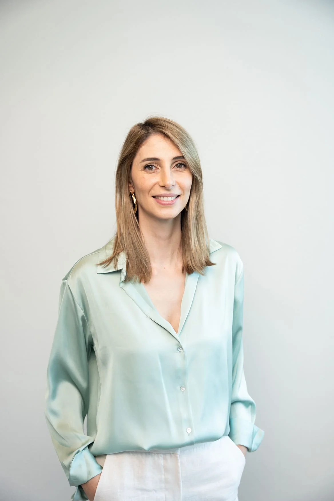 Rita Figueiredo, Peninsula's Psychologist and Director, sitting in a chair facing the photo.