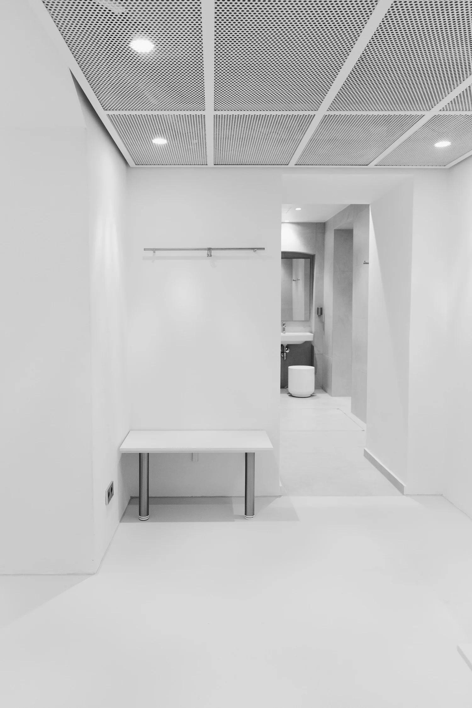 A calm white corridor inside the studio