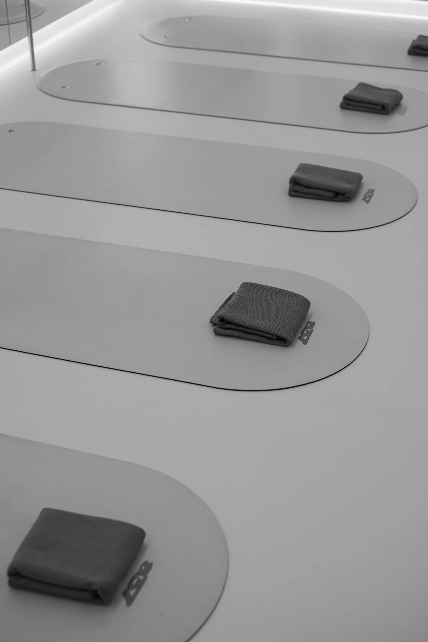 Mats laid out with folded towels, seen from above