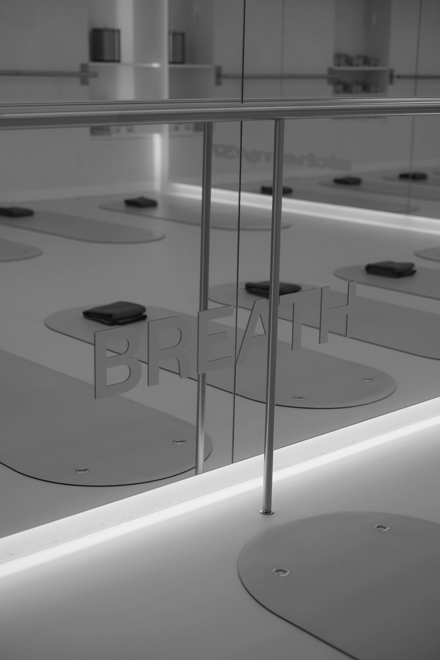 Glass-walled training room with mats