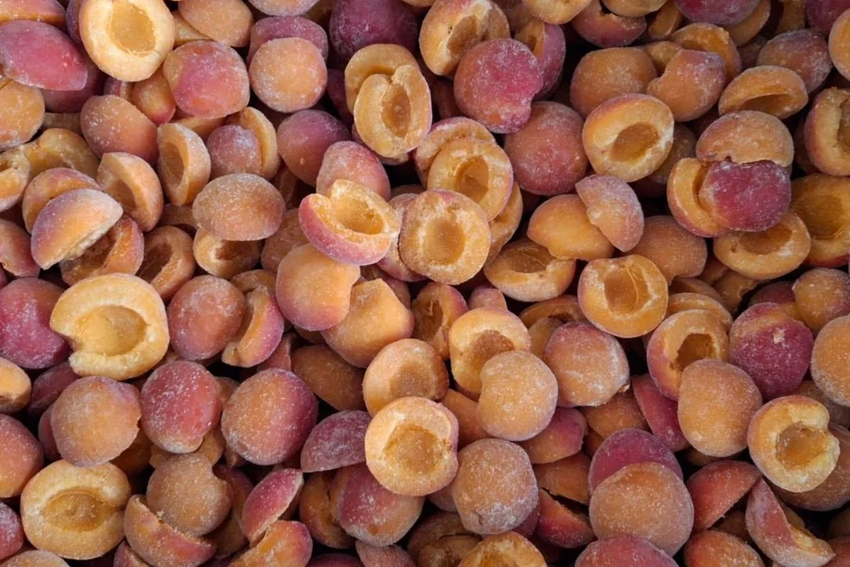 A close-up view of dried apricots with a dusty, icy appearance.
