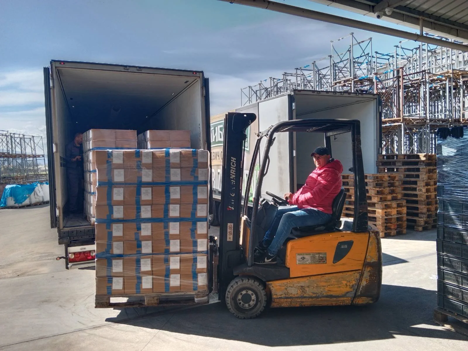Forklift loading pallets into truck