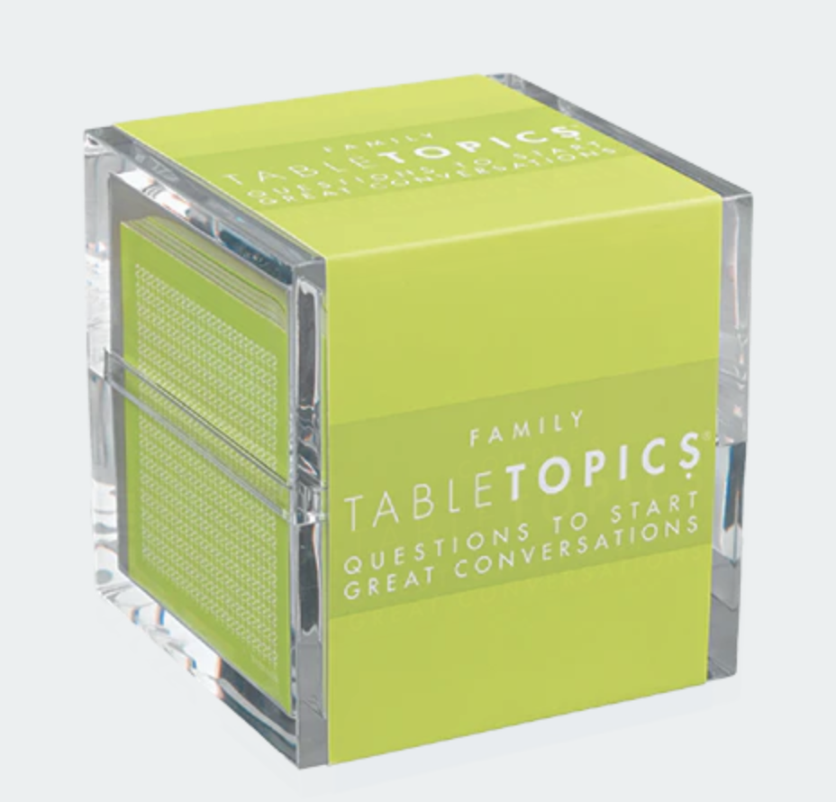 A clear acrylic cube with a bright green label on two sides, featuring the text 'Family TableTopics Questions to Start Great Conversations' in white.