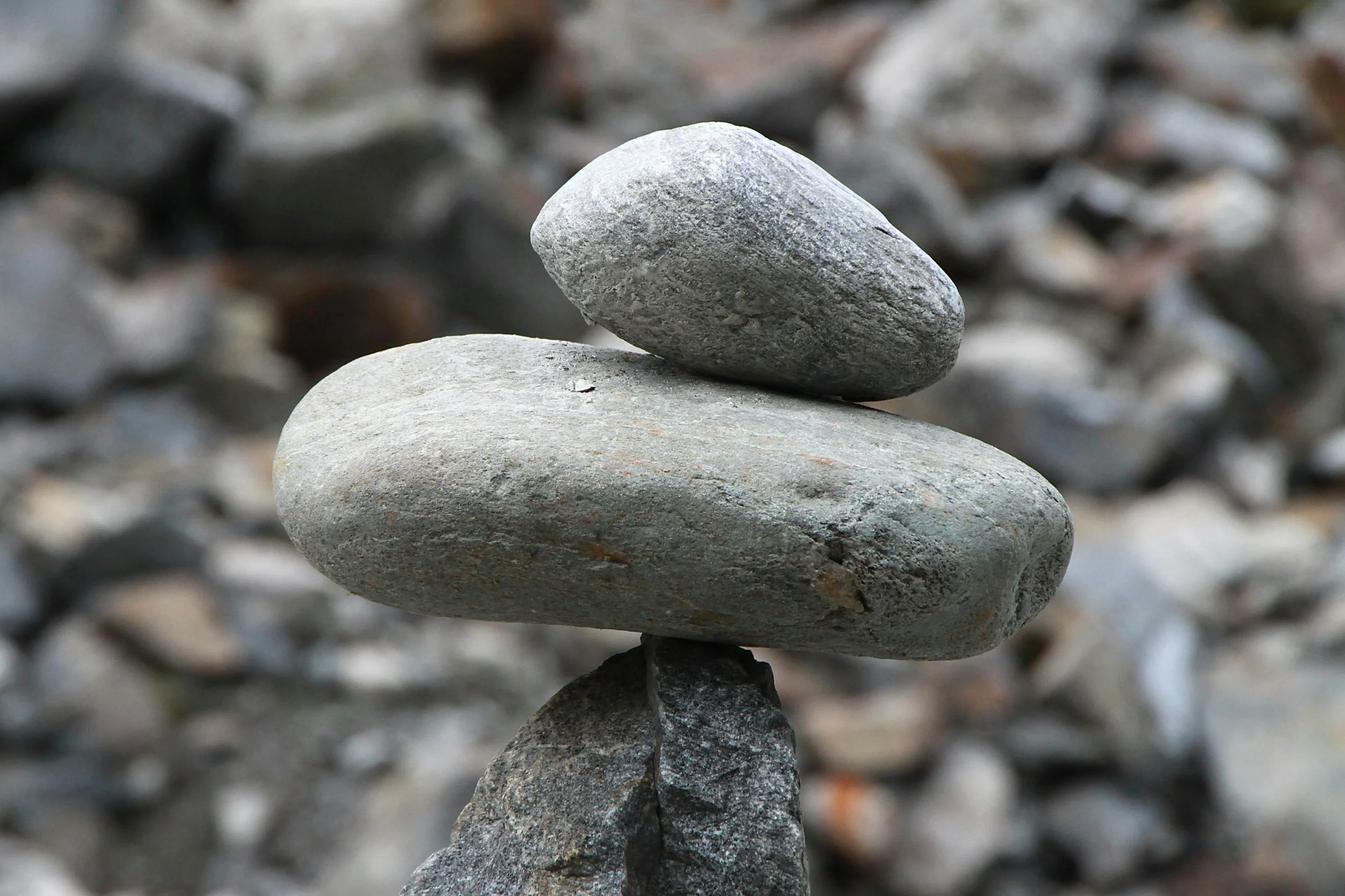 Stacked rocks with the background of a rocky surface.