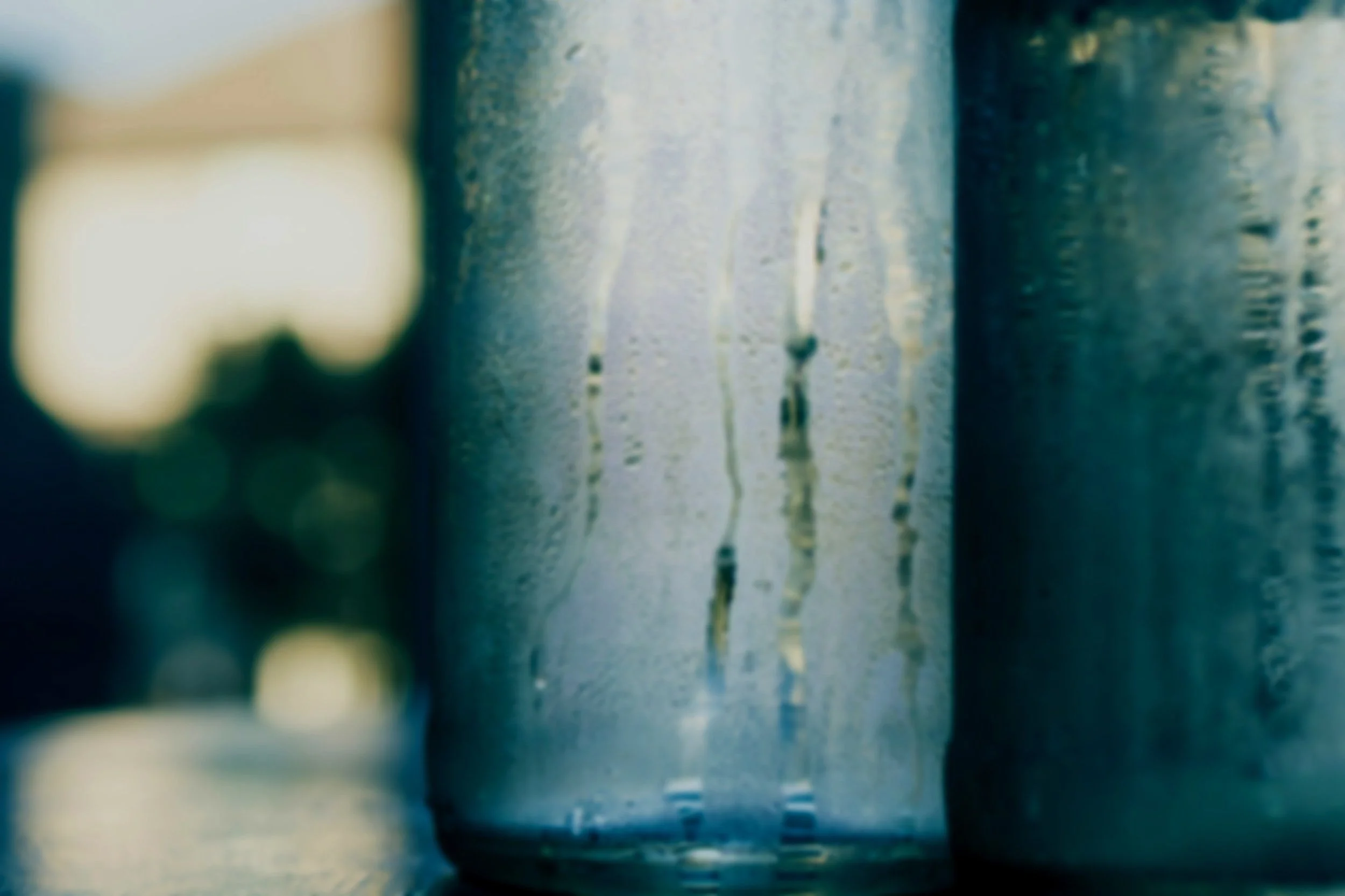 Close-up of frosted glass bottles with condensation.