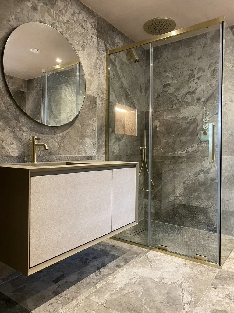 Master ensuite. Wall hung vanity. Free standing bath. Walk-in shower. Brass hardware. Hand held shower. Sports shower head. Rainfall shower head. Large format tiles. Recessed shelves.