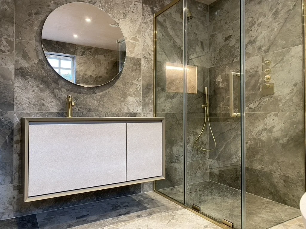 Master ensuite. Wall hung vanity. Free standing bath. Walk-in shower. Brass hardware. Hand held shower. Sports shower head. Rainfall shower head. Large format tiles. Recessed shelves.