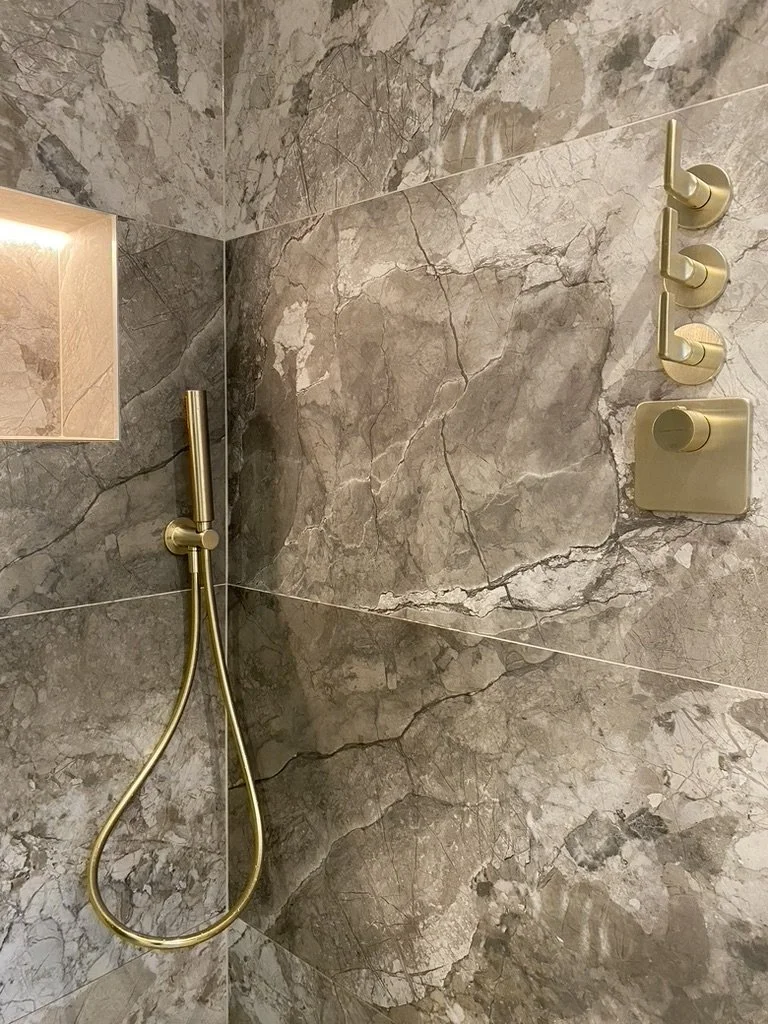 Master ensuite. Wall hung vanity. Free standing bath. Walk-in shower. Brass hardware. Hand held shower. Sports shower head. Rainfall shower head. Large format tiles. Recessed shelves.
