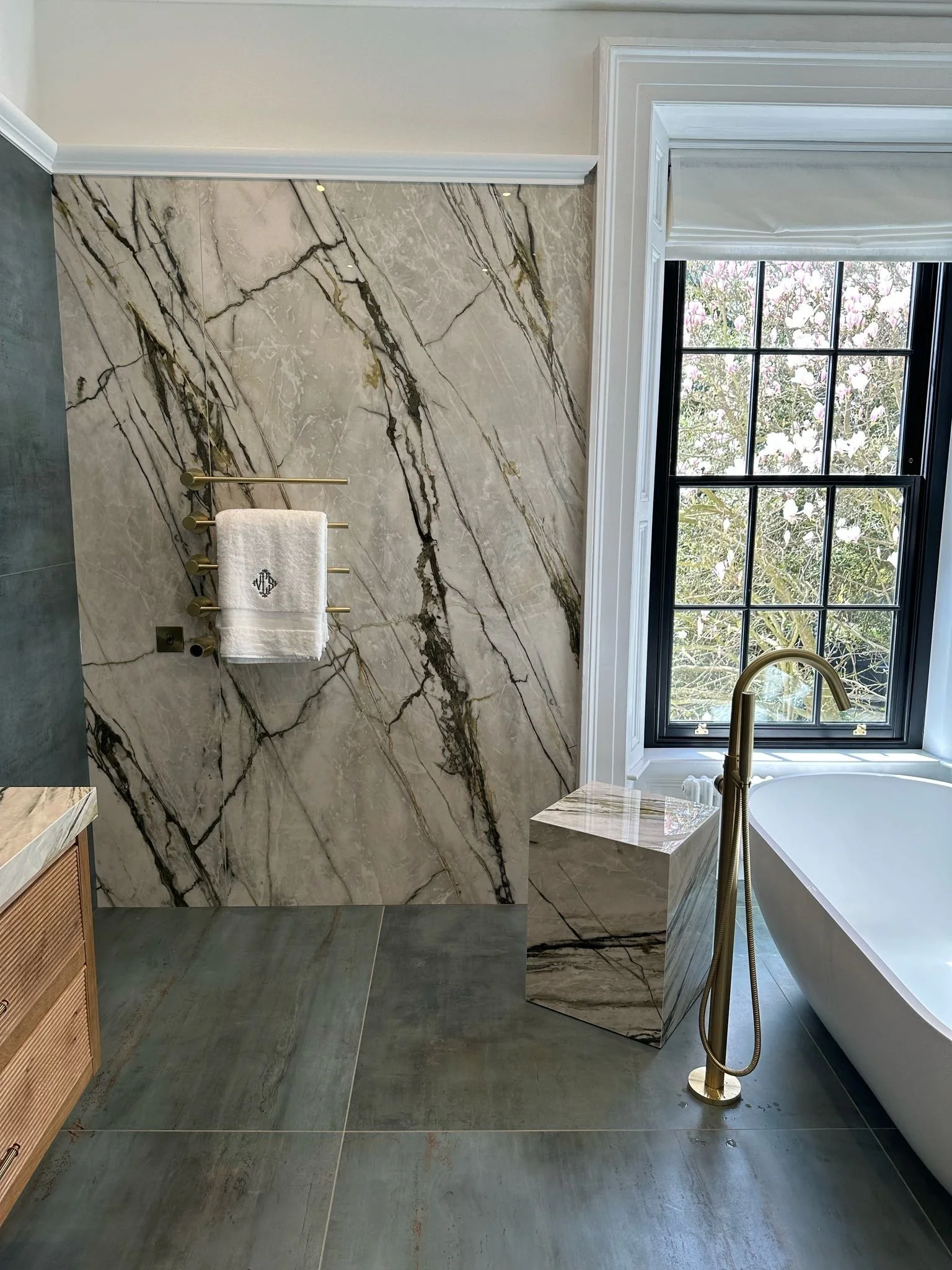 Large family bathroom. Double shower. Large format tiles. Recessed shelves. Mitred edges. Double vanity. Bespoke double basins. Illuminated mirrors. Free standing bath. Floor mounted bath tap.