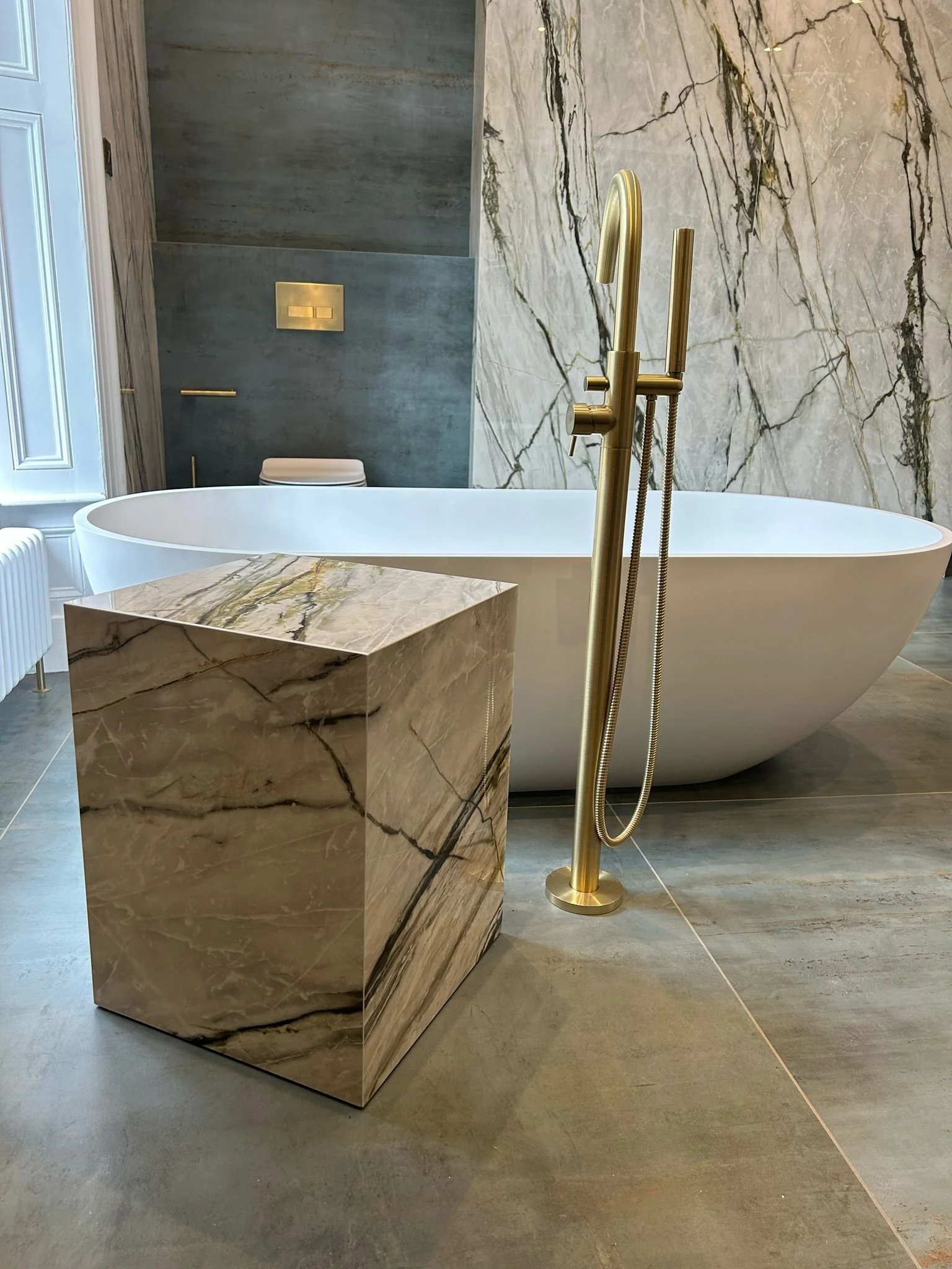 Large family bathroom. Double shower. Large format tiles. Recessed shelves. Mitred edges. Double vanity. Bespoke double basins. Illuminated mirrors. Free standing bath. Floor mounted bath tap.