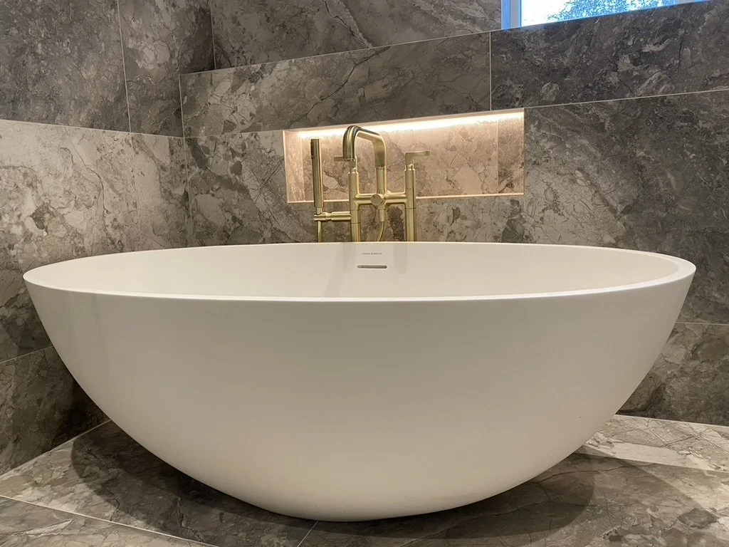 Master ensuite. Wall hung vanity. Free standing bath. Walk-in shower. Brass hardware. Hand held shower. Sports shower head. Rainfall shower head. Large format tiles. Recessed shelves.