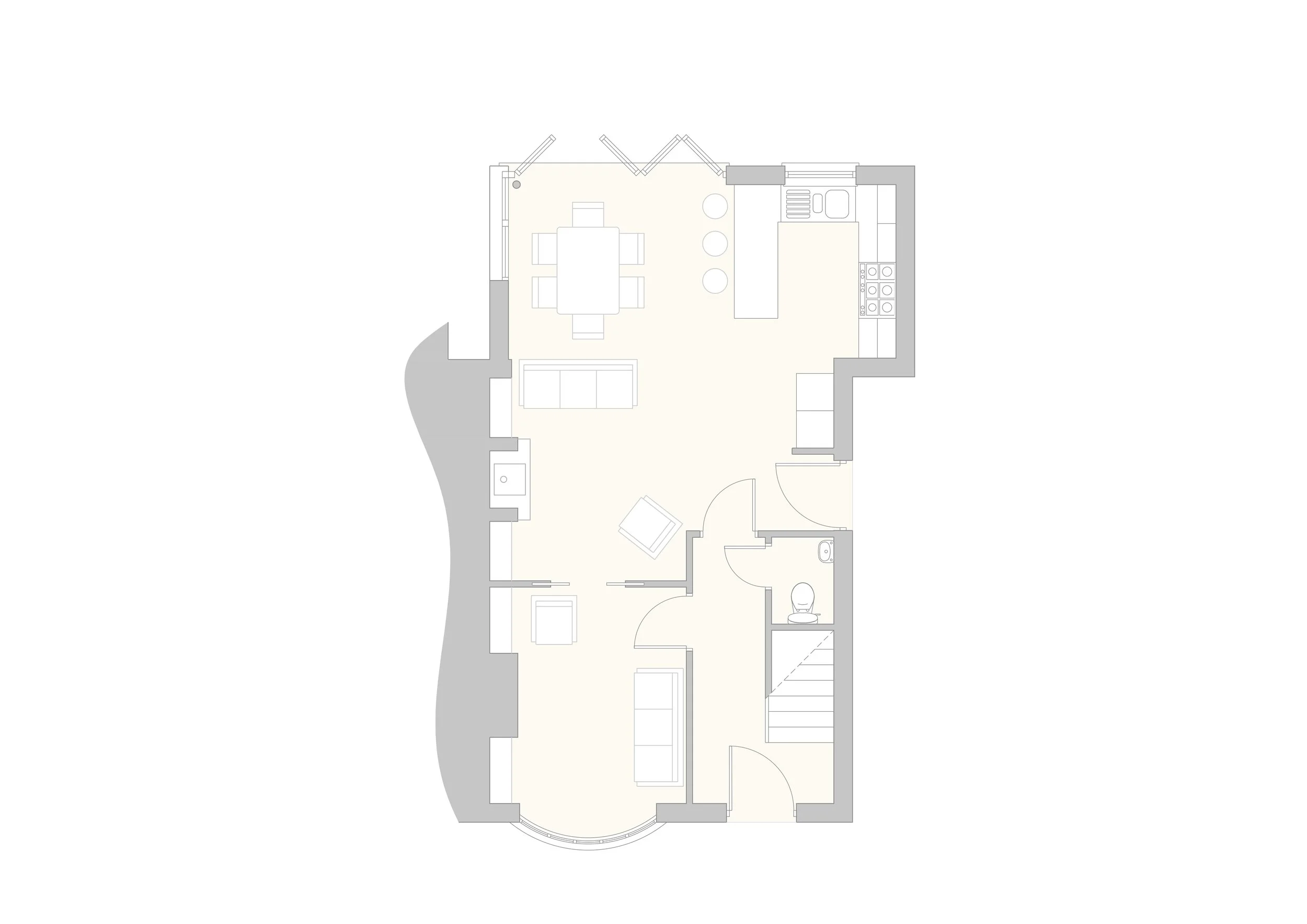 Architectural floor plan featuring a living room, dining area set with a table and chairs, a kitchen with appliances, a small bathroom, and stairs. Open layout with defined spaces.