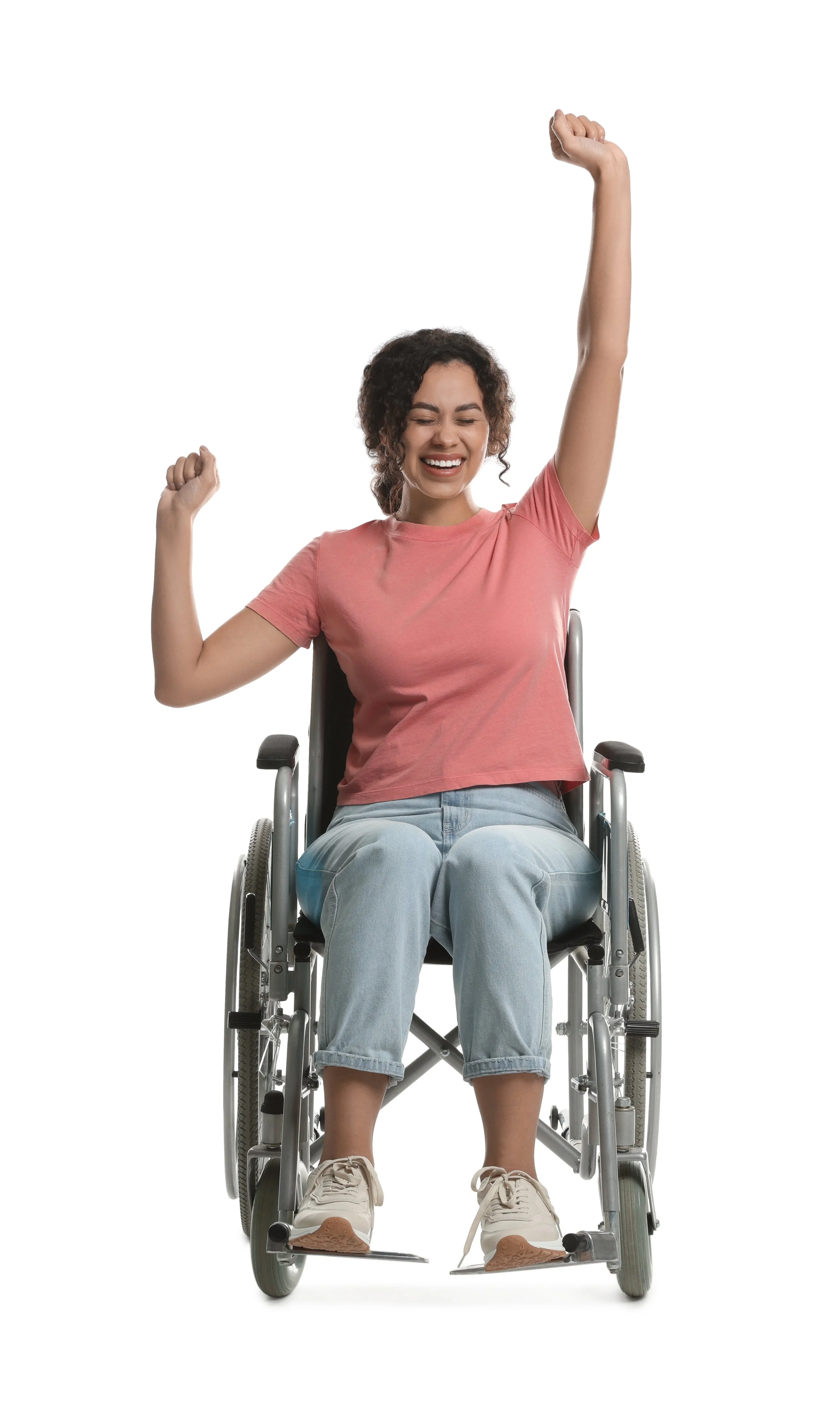 Woman in wheelchair celebrating with raised arms, wearing a pink shirt and jeans.