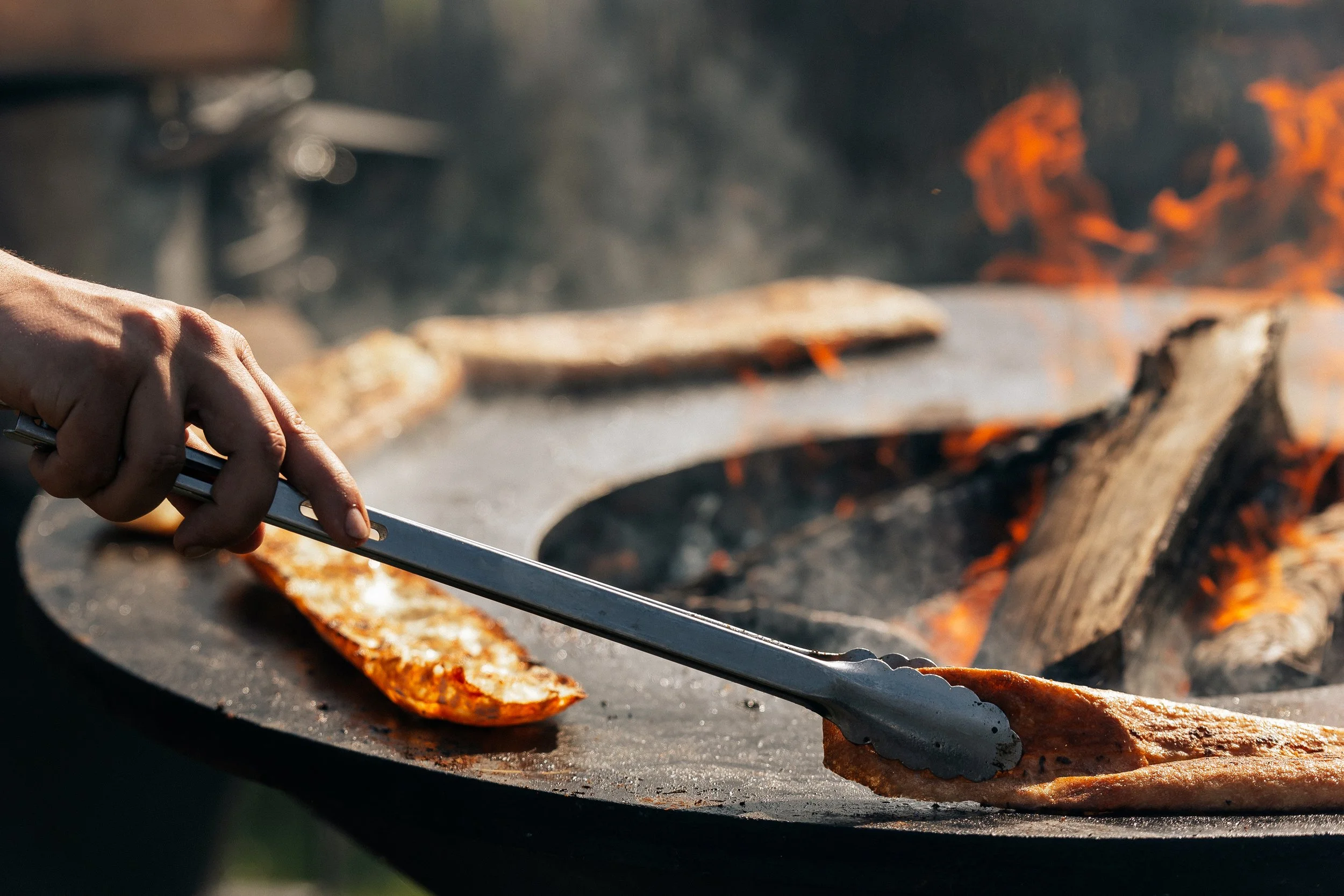 Grilling bread over an open flame.