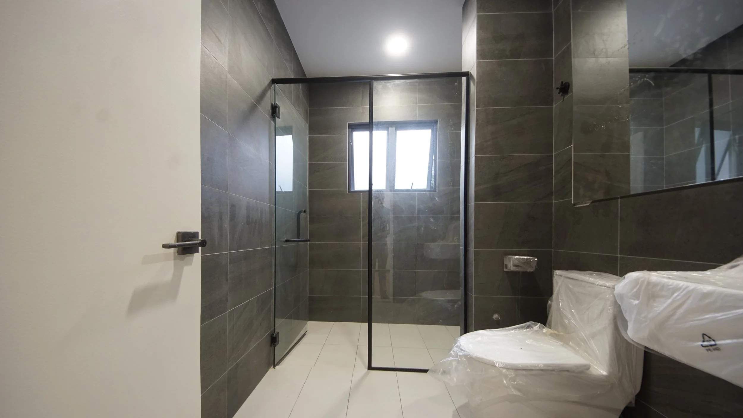 Modern bathroom with glass shower and tiled walls